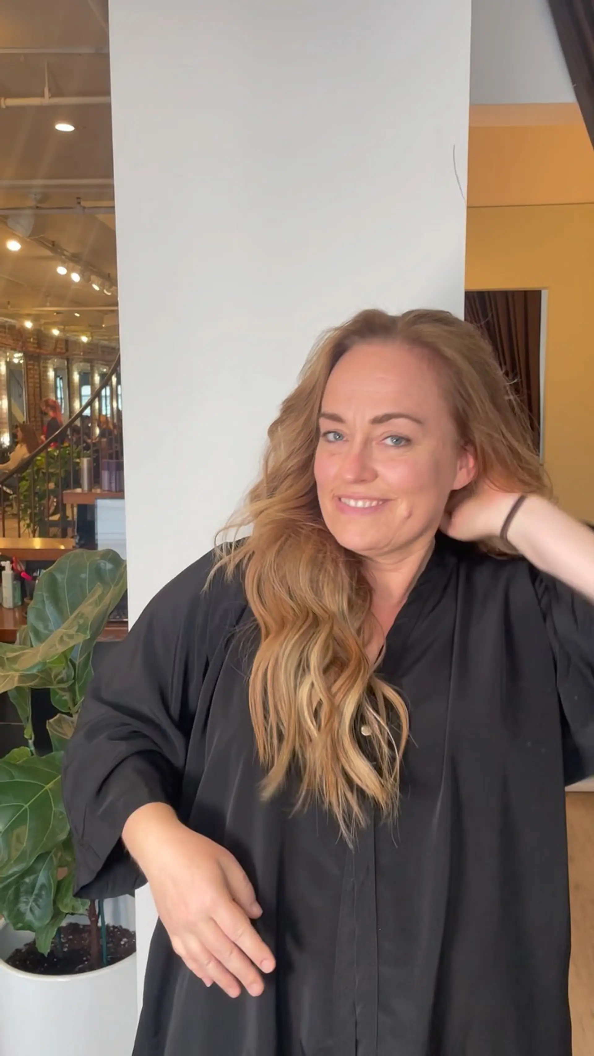 Long, dimensional warm blonde hair styled in loose, natural waves with added volume and seamless blending. 1