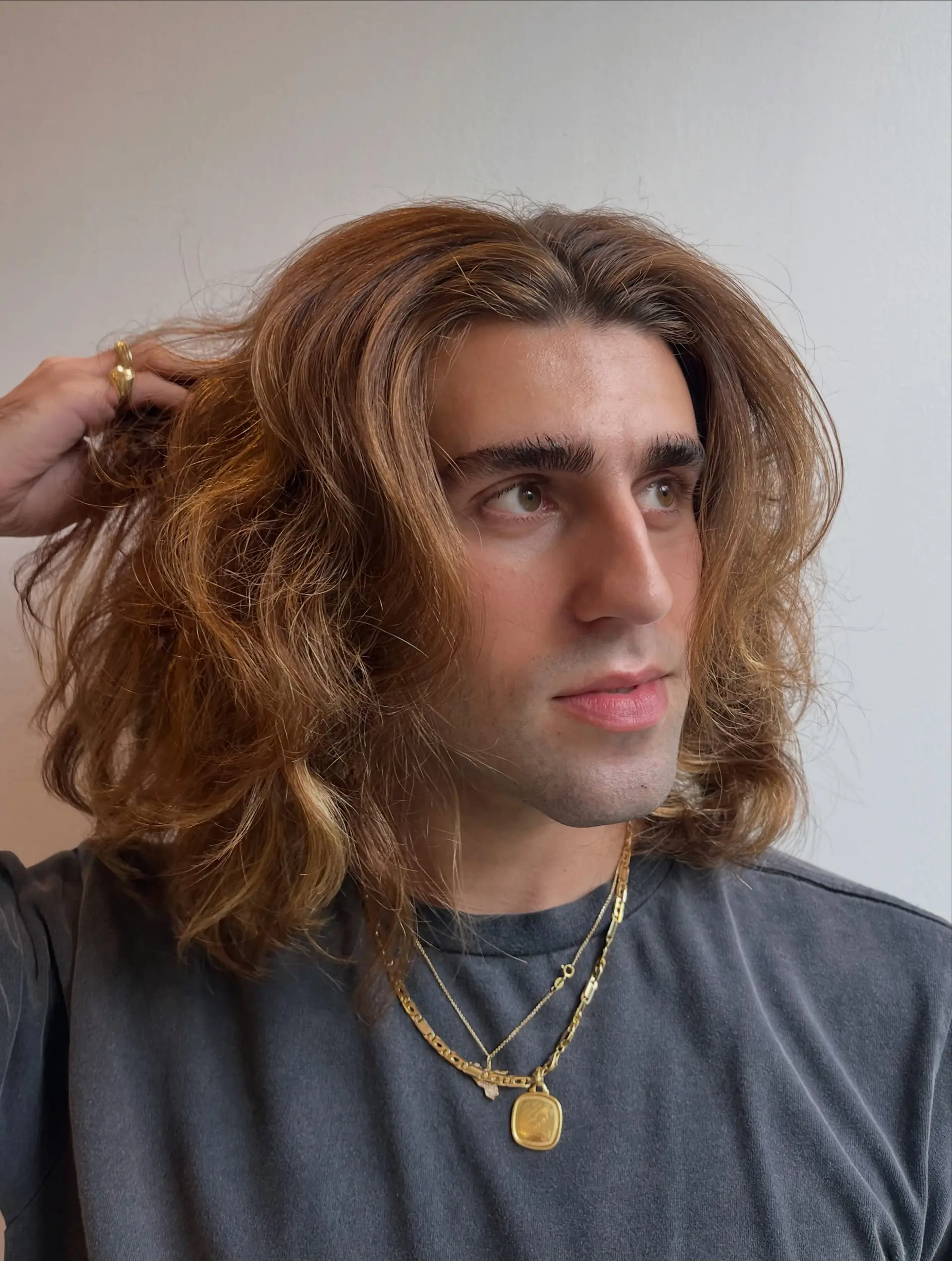 Medium shoulder-length haircut with natural waves, soft layered volume, and face-framing movement. 1