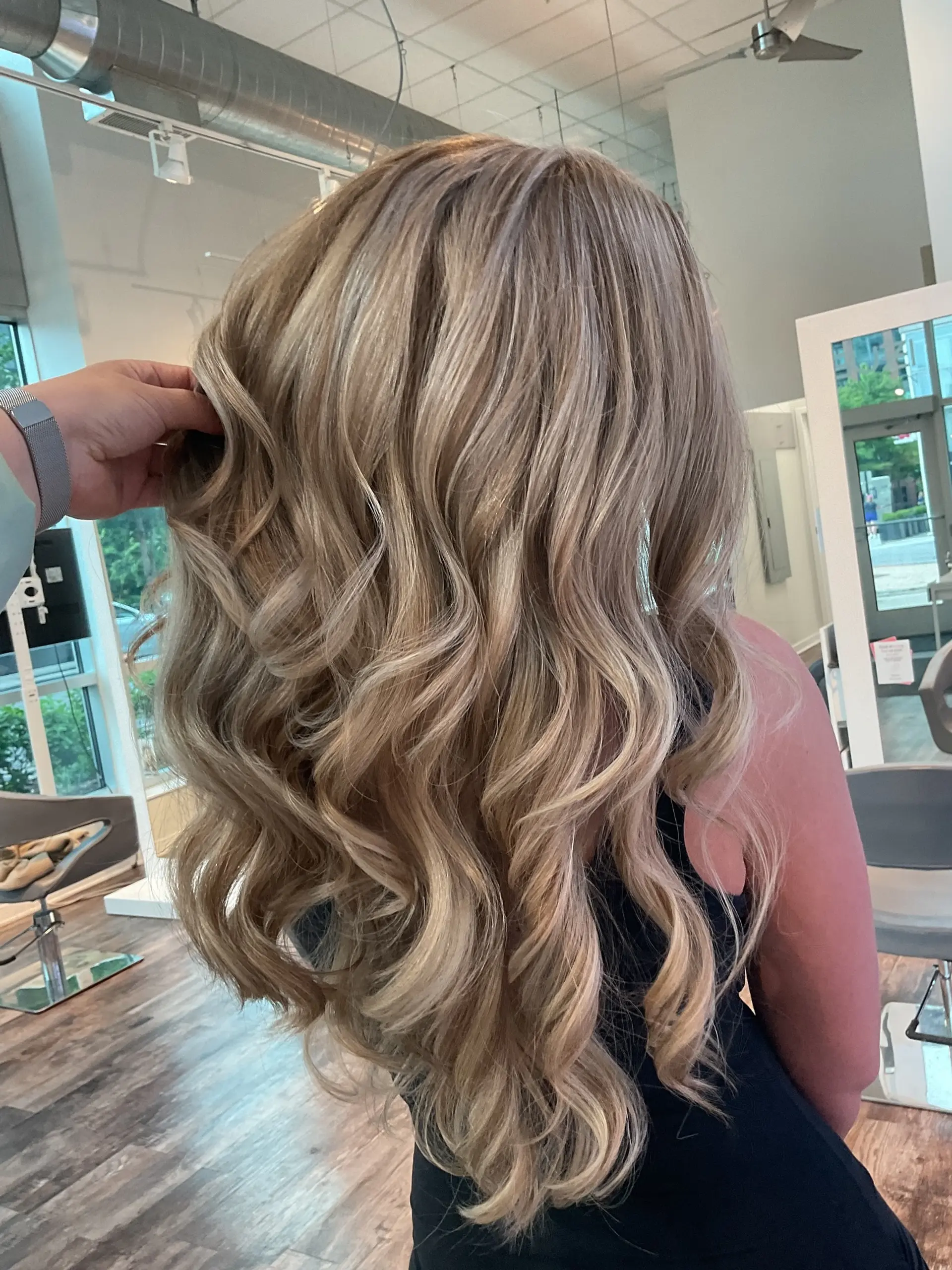 Long, flowing waves with a seamless, sun-kissed blonde balayage. 1