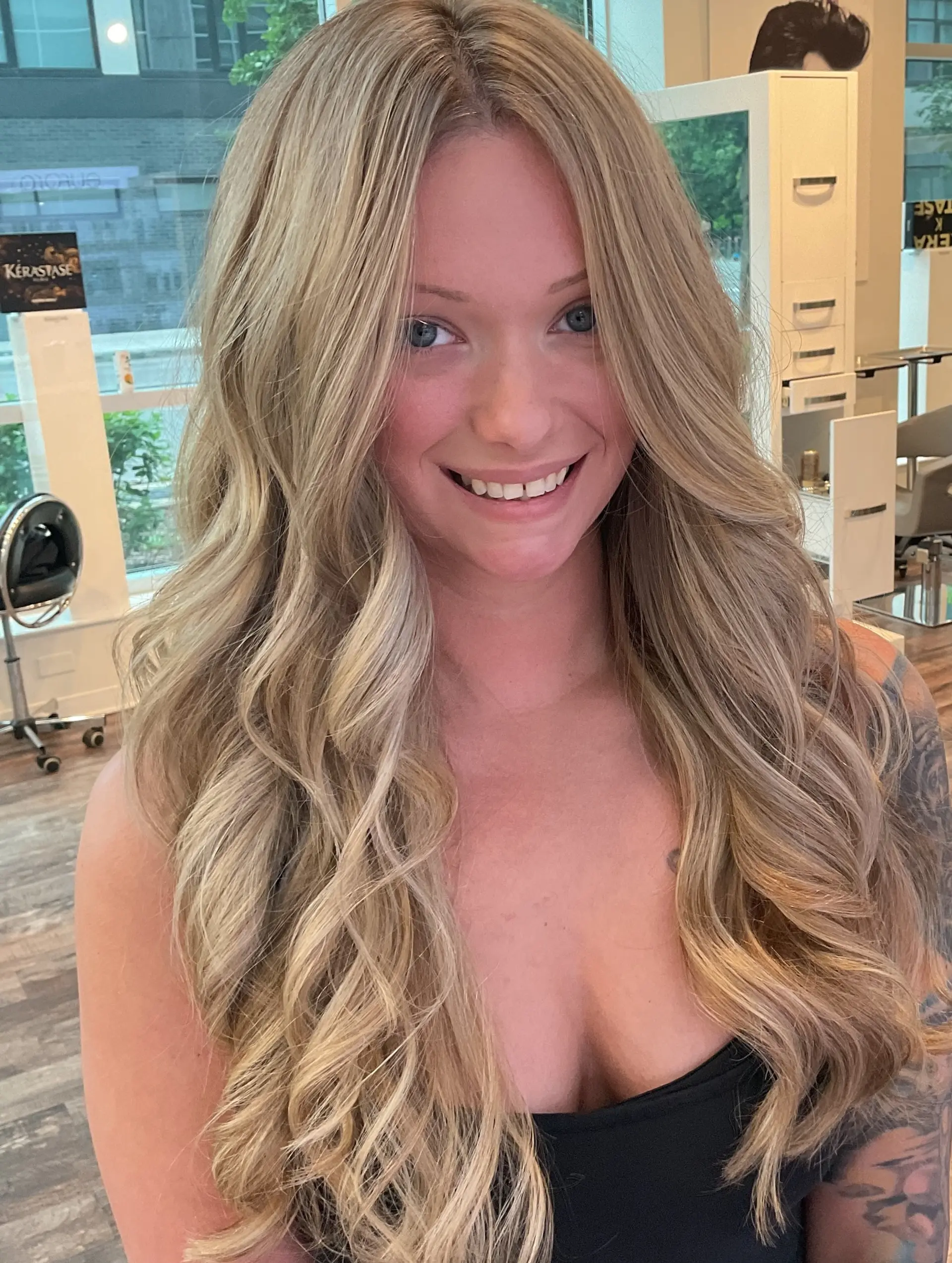Long, flowing waves with a seamless, sun-kissed blonde balayage. 2