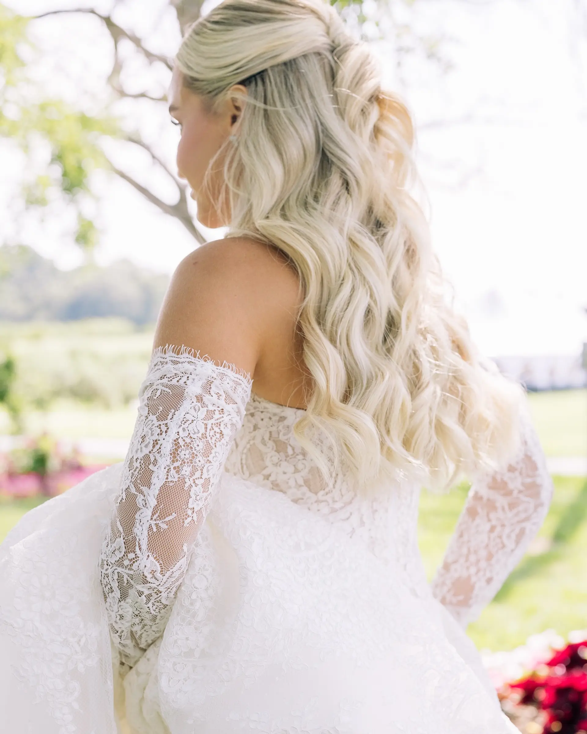 Long, wavy blonde hair styled in a half-up fashion, creating an elegant and romantic look. 1