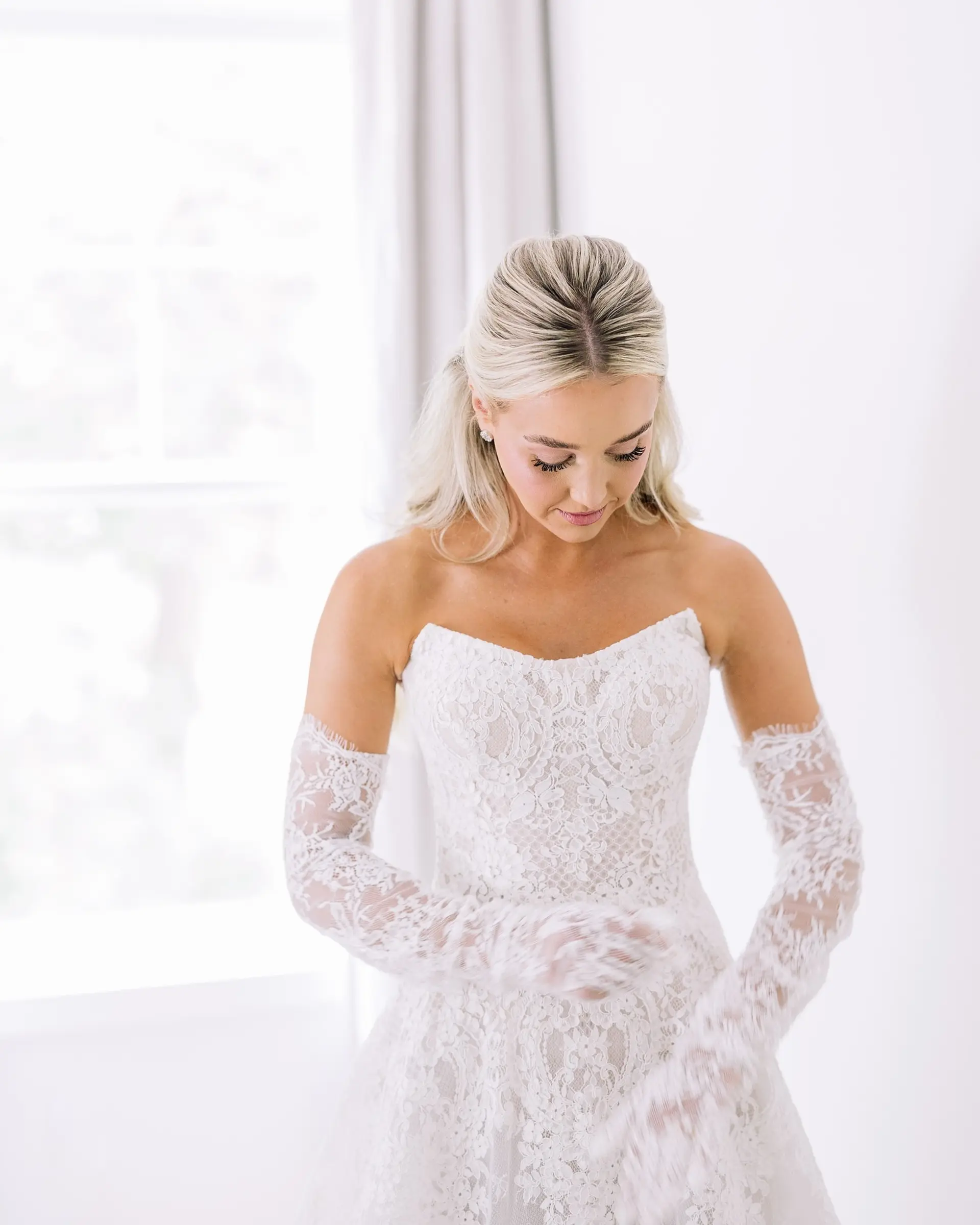 Long, wavy blonde hair styled in a half-up fashion, creating an elegant and romantic look. 2