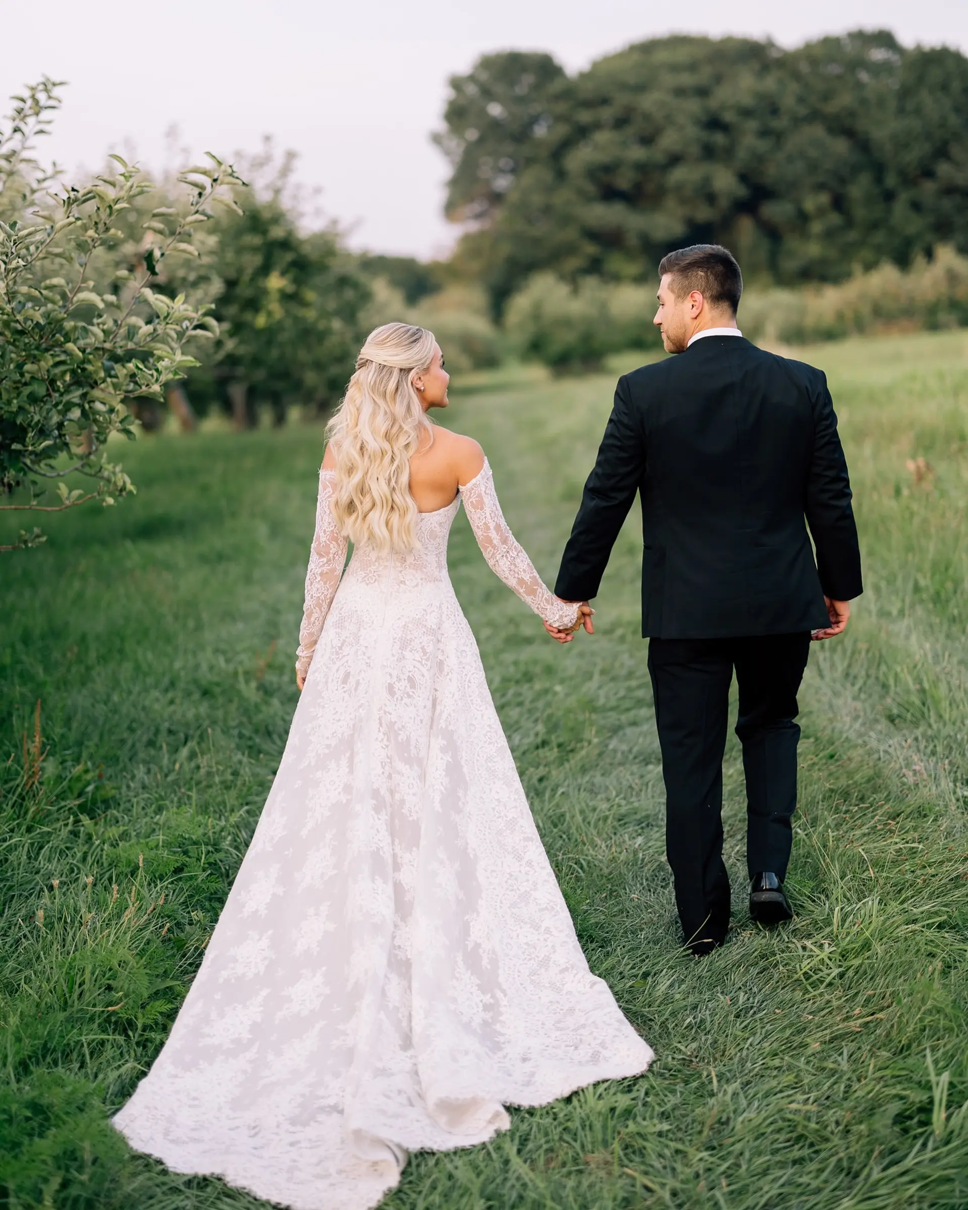 Long, wavy blonde hair styled in a half-up fashion, creating an elegant and romantic look. 3