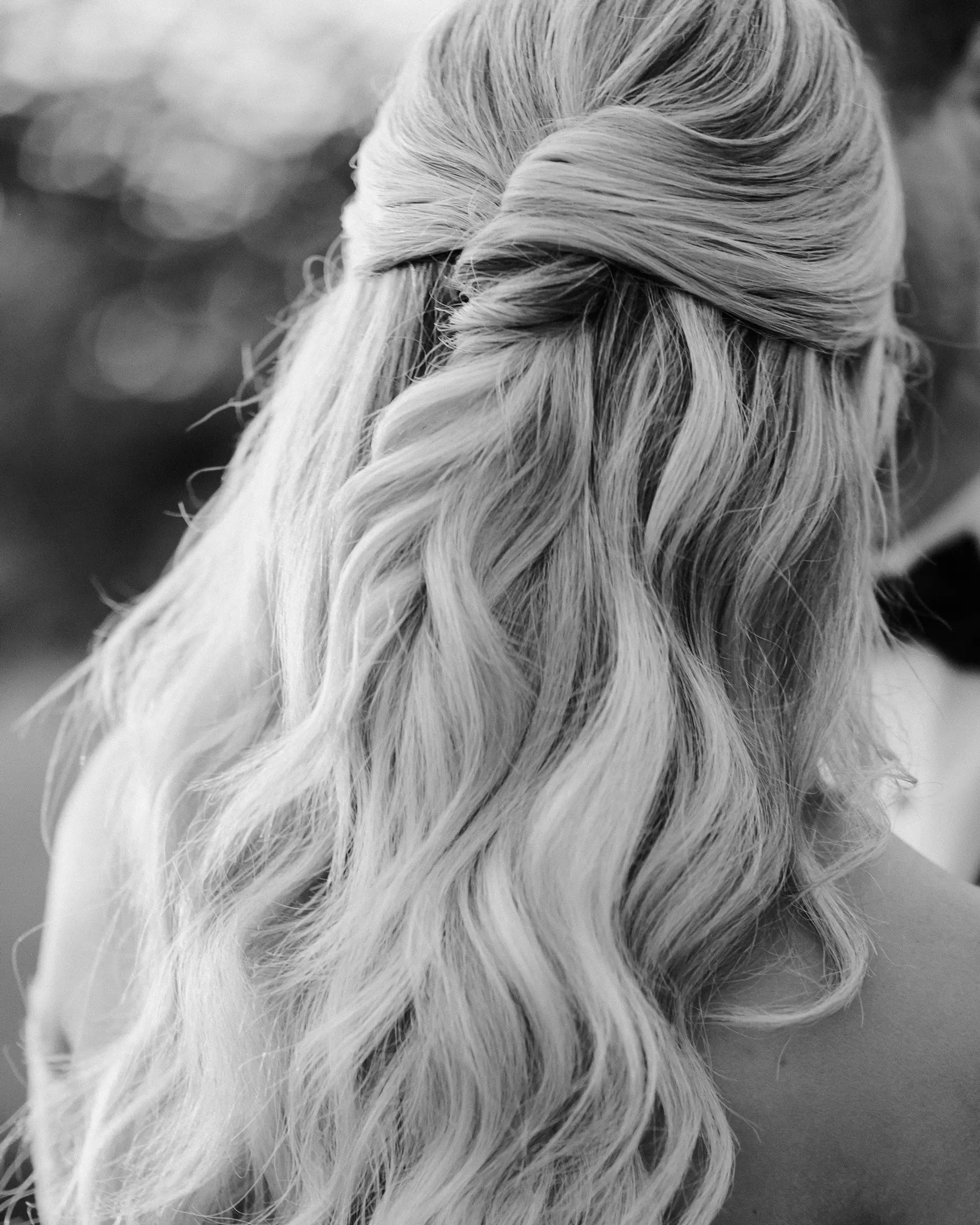 Long, wavy blonde hair styled in a half-up fashion, creating an elegant and romantic look. 4
