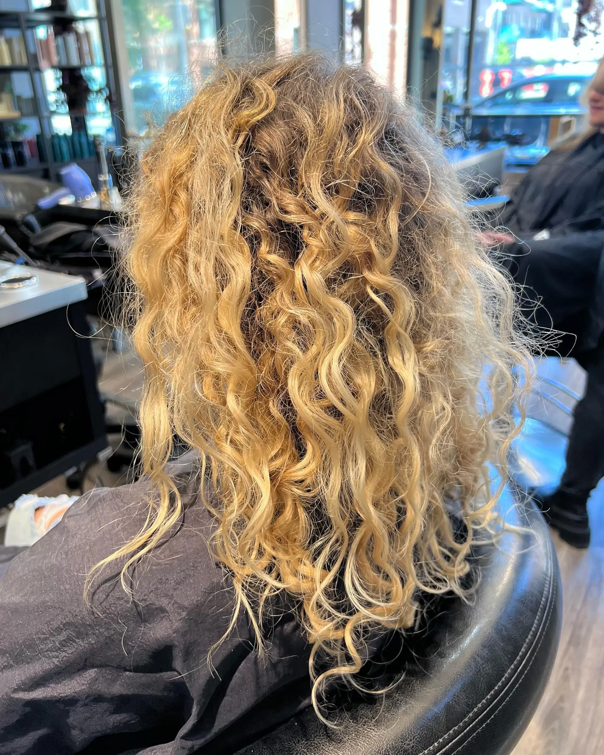 A medium-length curly perm with defined curls for a voluminous look. 2