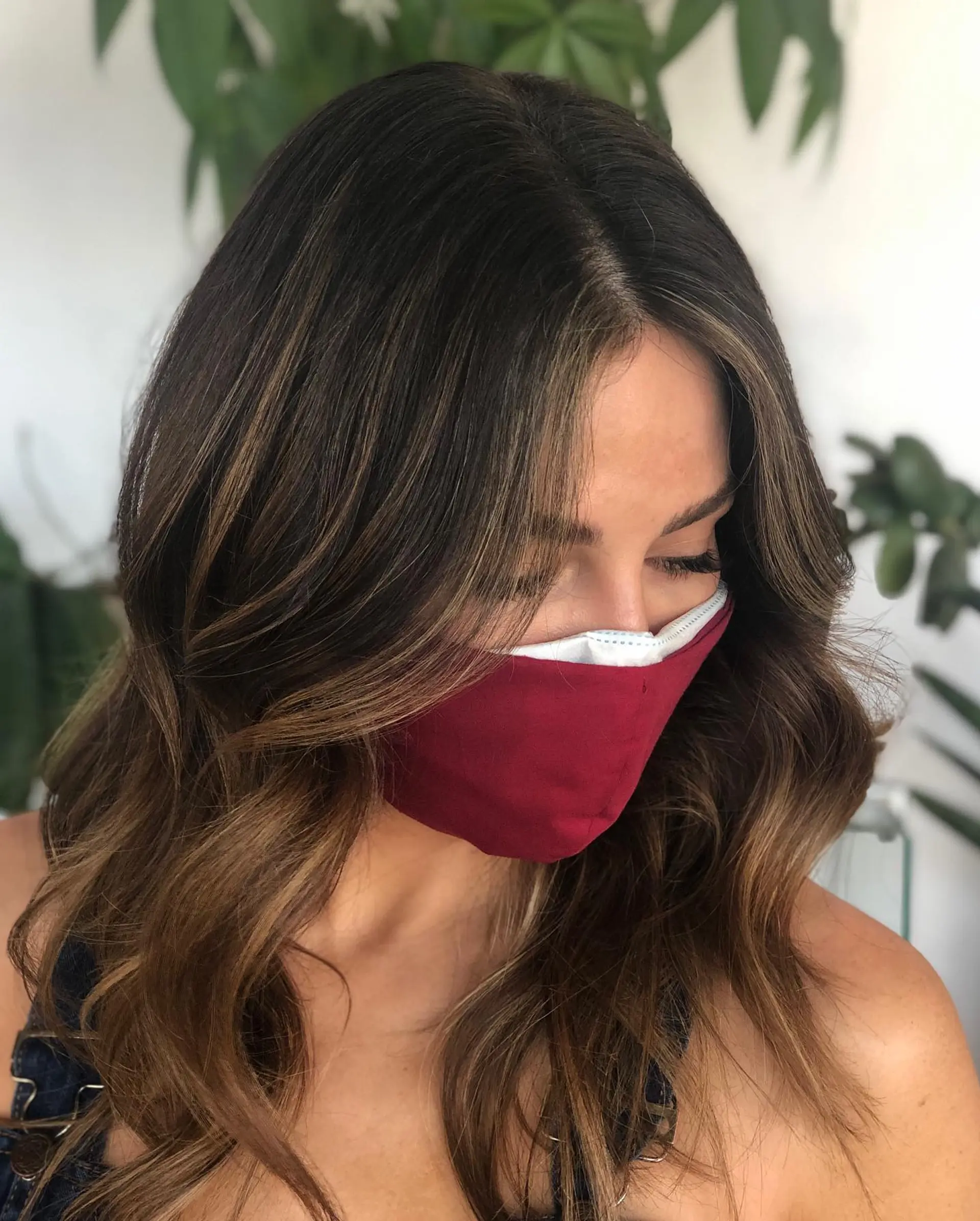 Rich brunette hair styled into soft, dimensional waves with caramel balayage and delicate face-framing babylights. 1