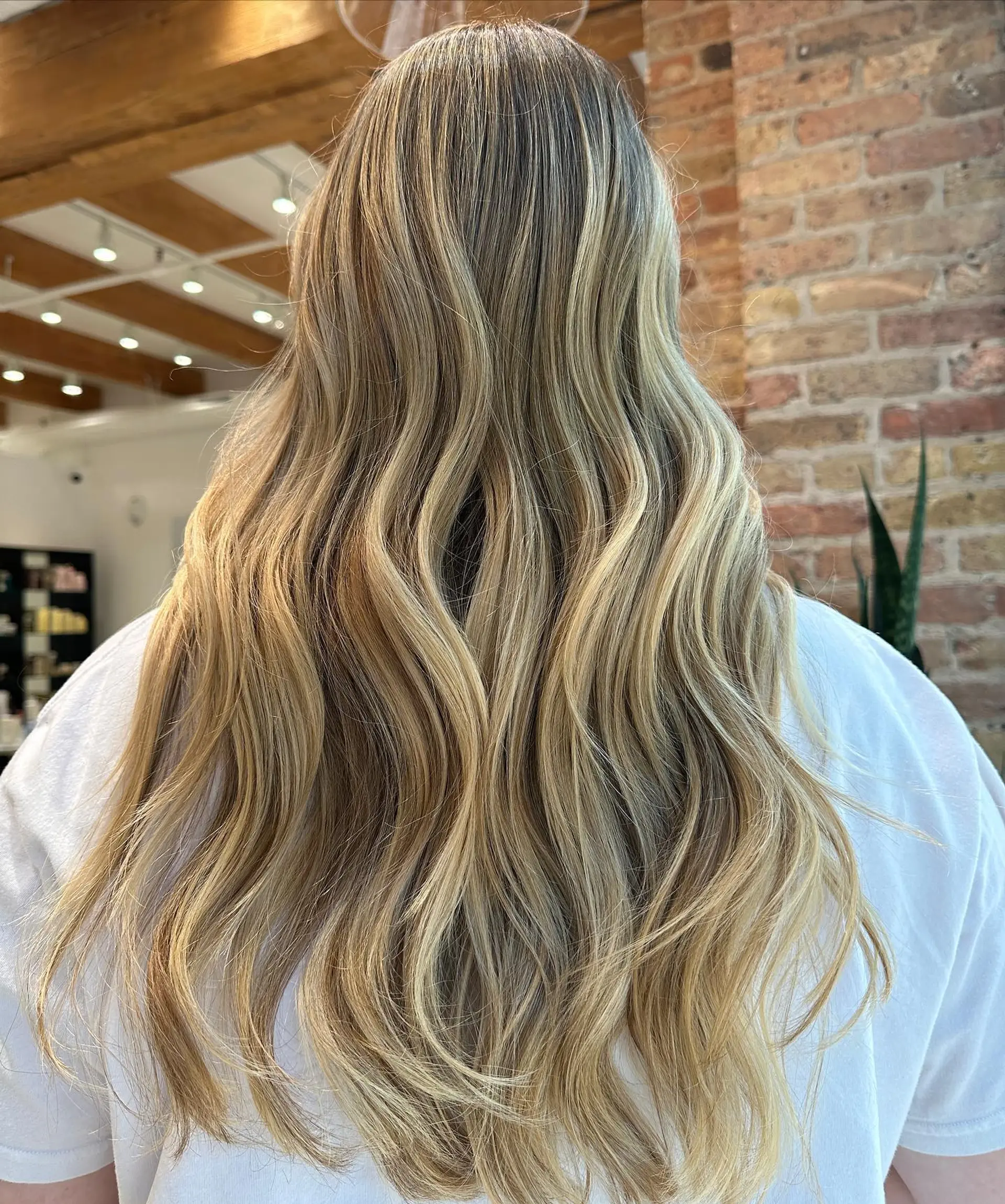 Long, wavy hair with a blonde balayage. 1