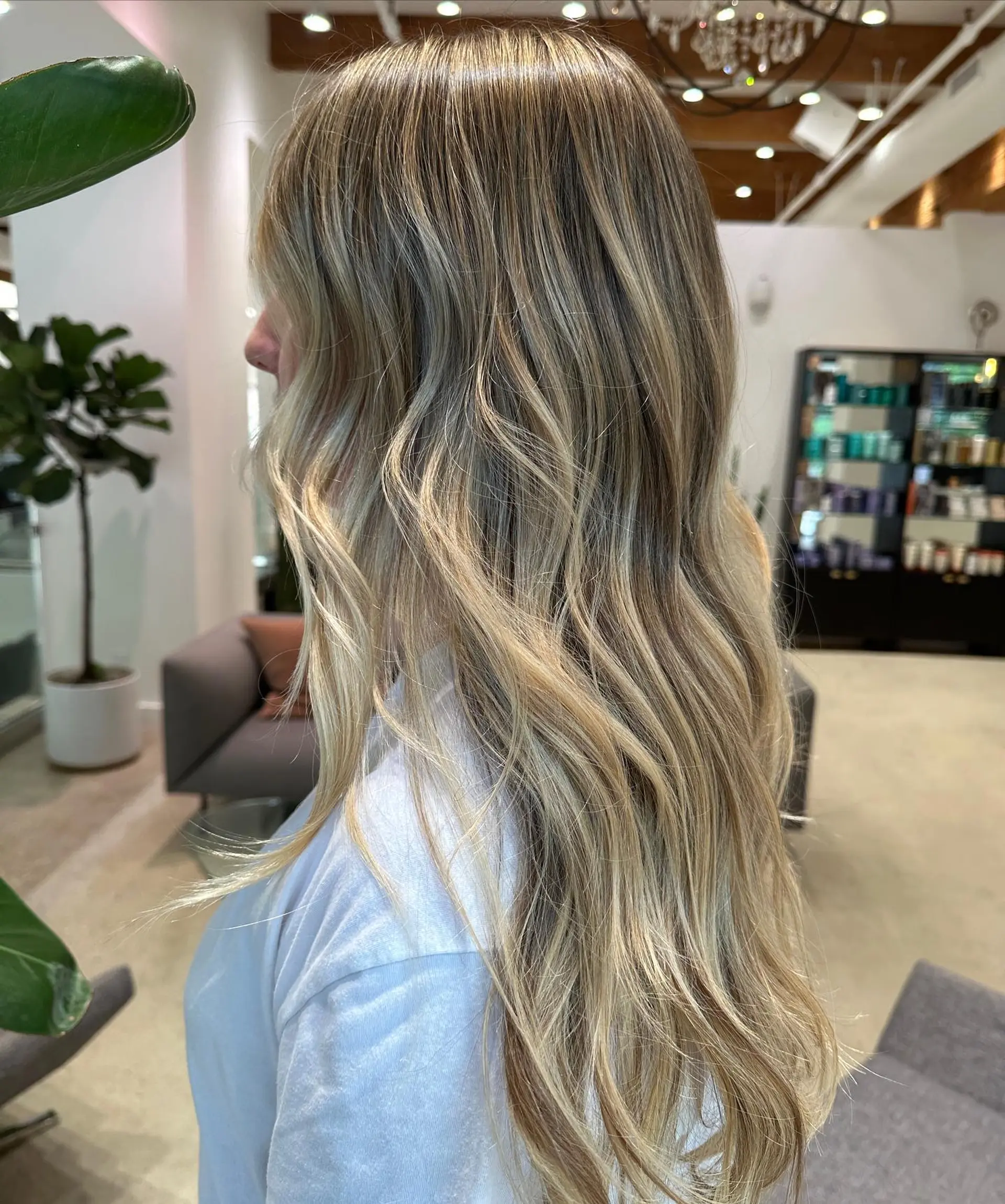 Long, wavy hair with a blonde balayage. 2