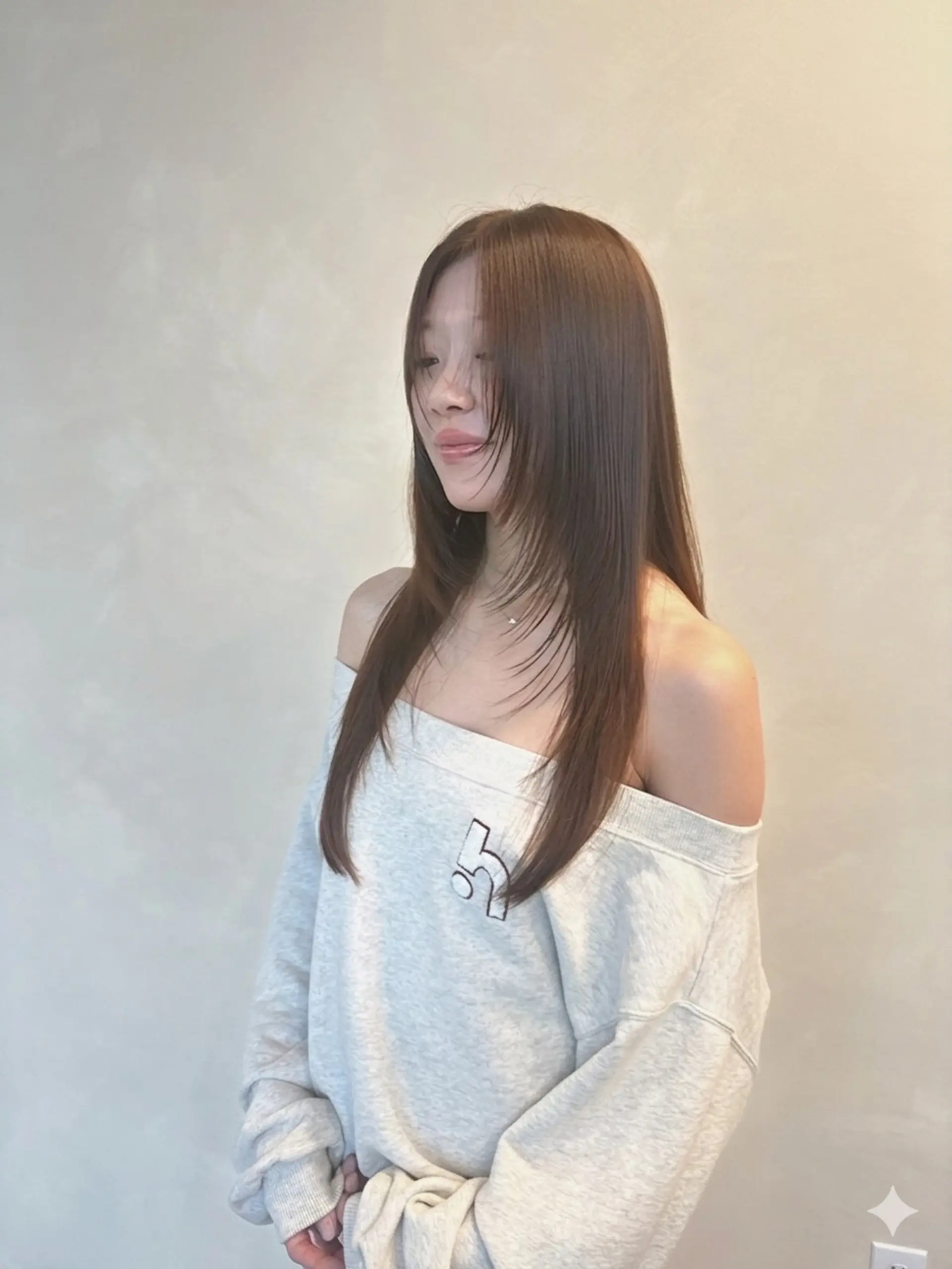 A sleek, straight long haircut featuring soft face-framing layers in an even, glossy medium brown tone. 1