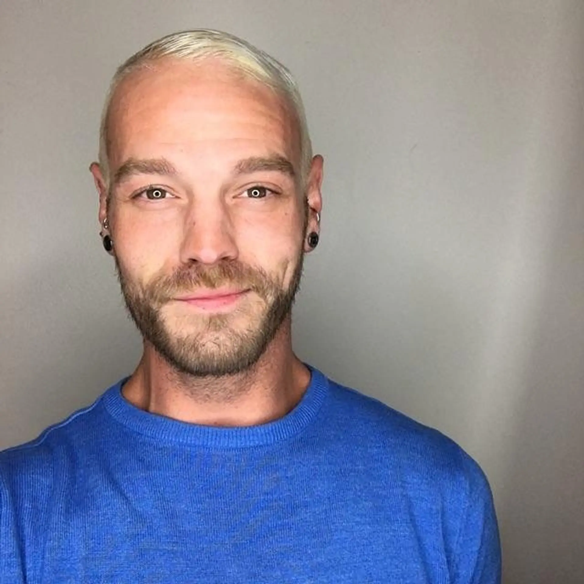 A clean and edgy buzz cut, bleached to a platinum blonde. 1