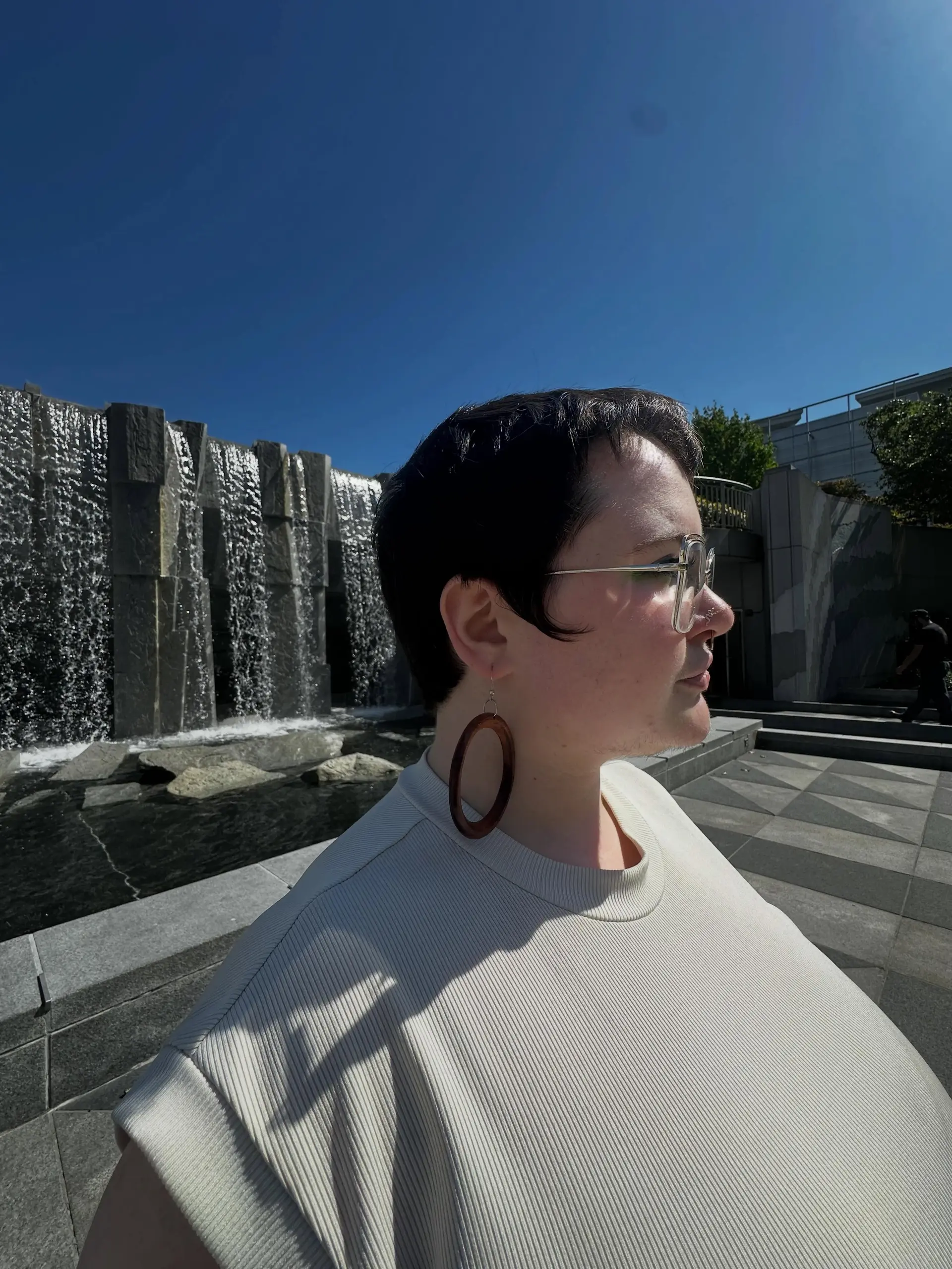 A classic short pixie cut featuring soft sideburns and light texture throughout the top. 1