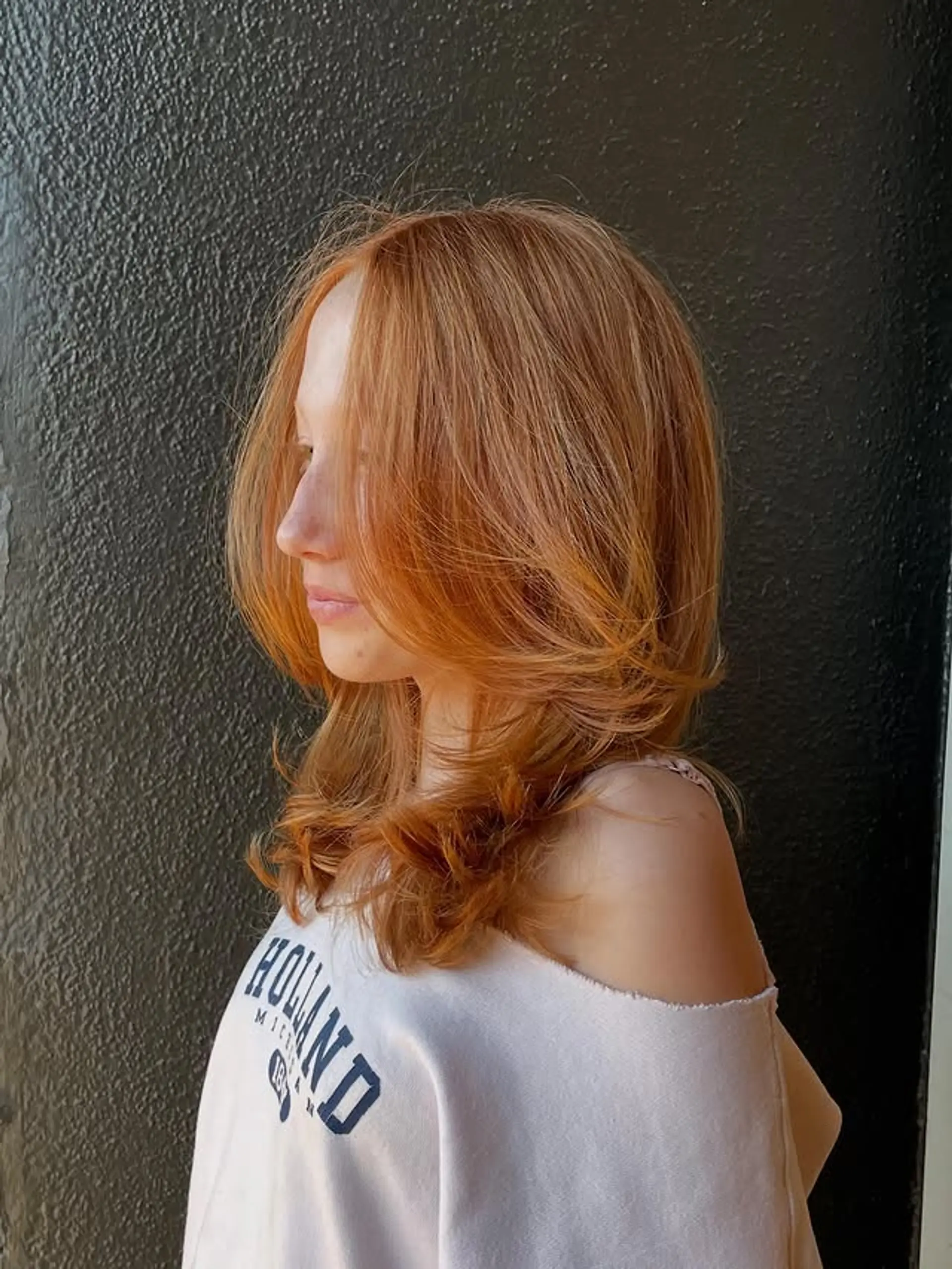 This is a copper medium-length layered haircut with face-framing. 1