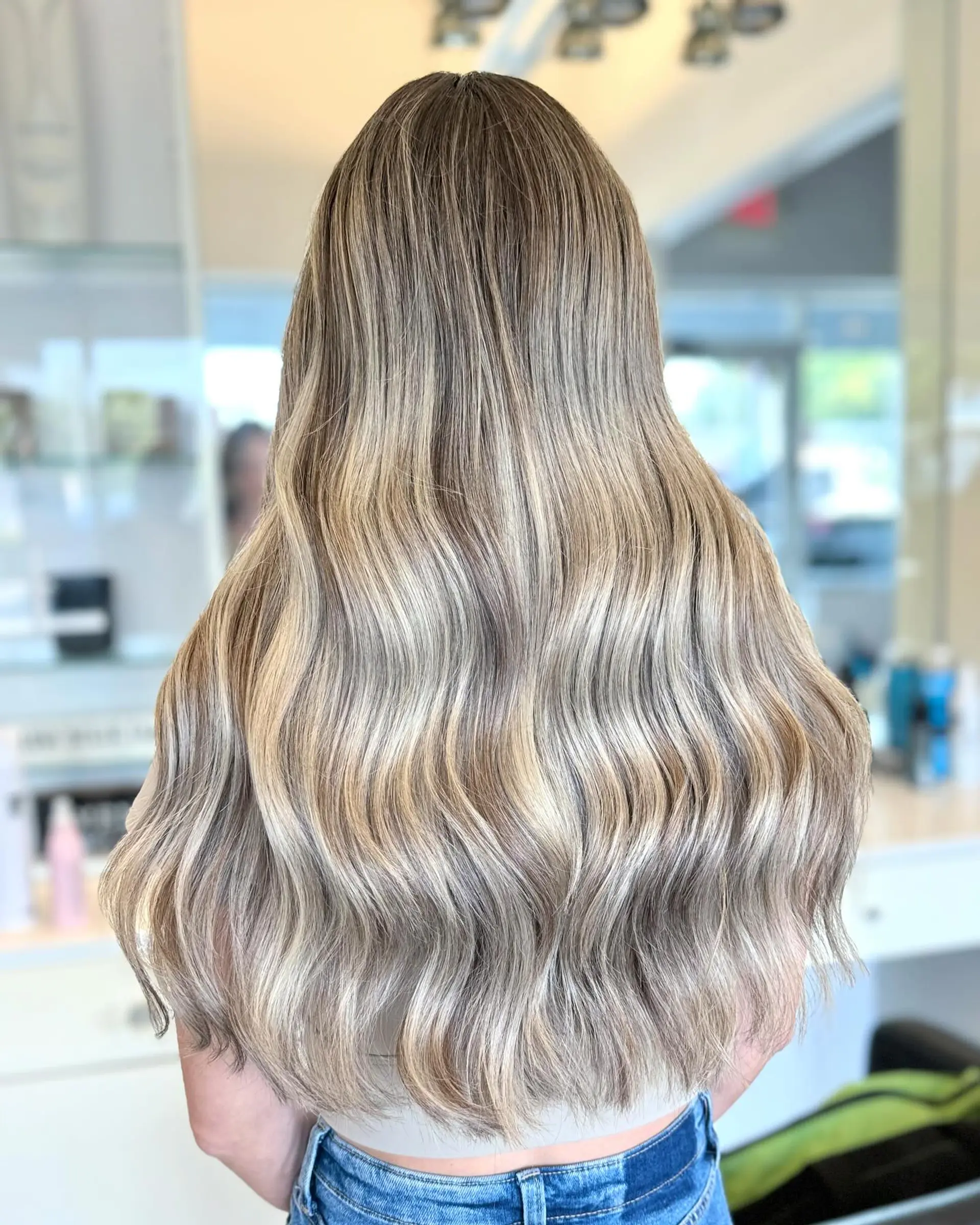 Long, flowing beach waves with a dimensional blonde balayage. 1