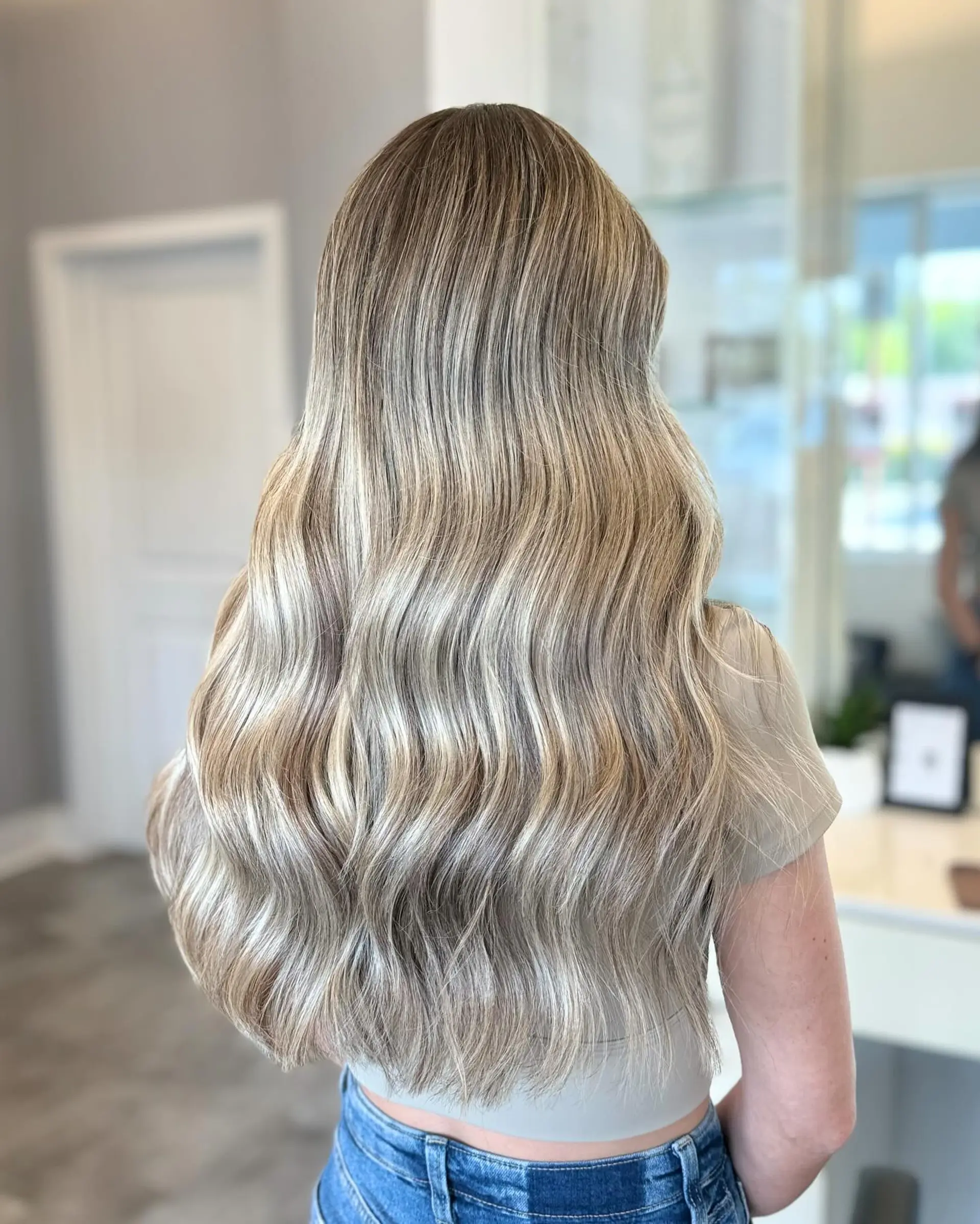 Long, flowing beach waves with a dimensional blonde balayage. 4