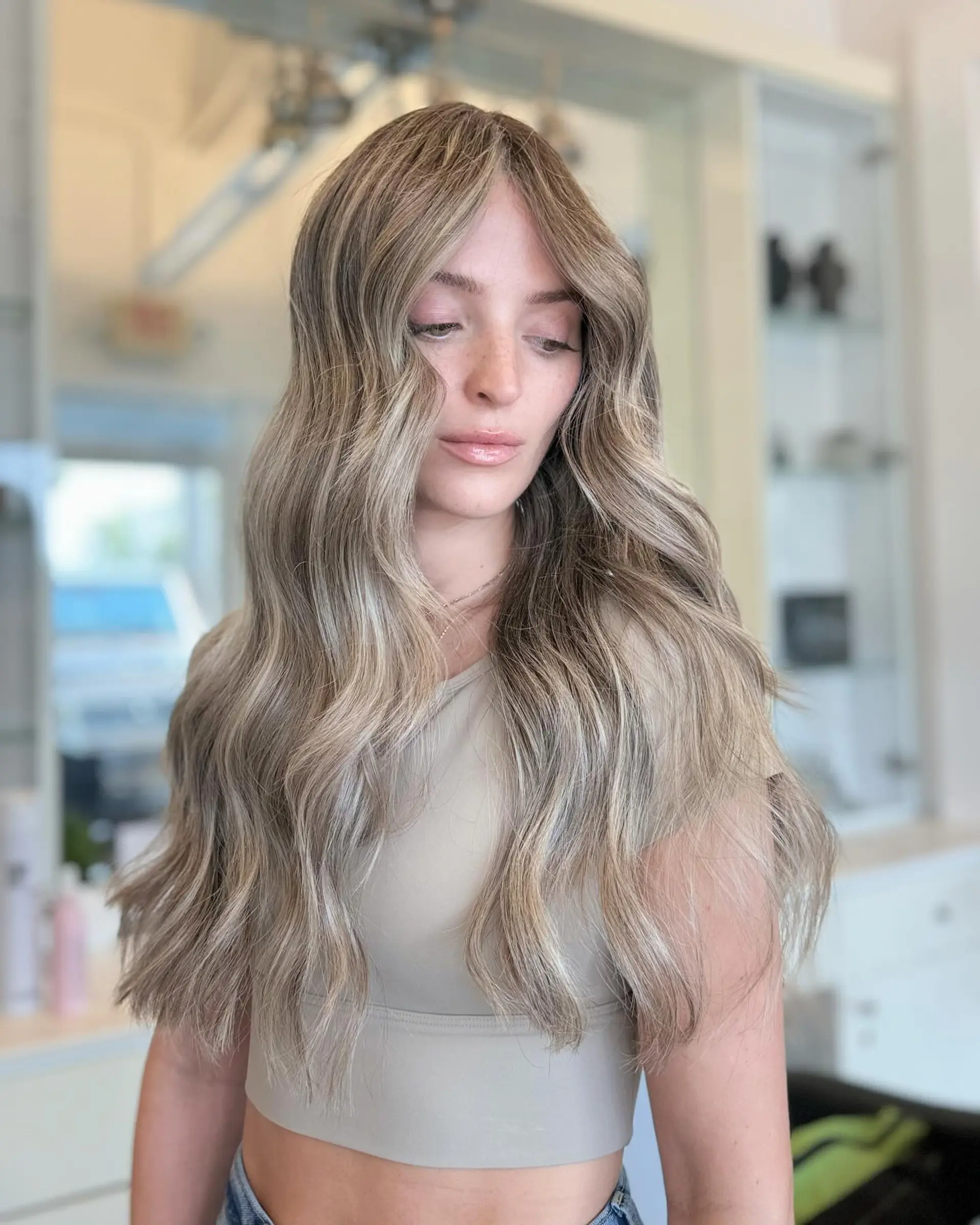 Long, flowing beach waves with a dimensional blonde balayage. 5