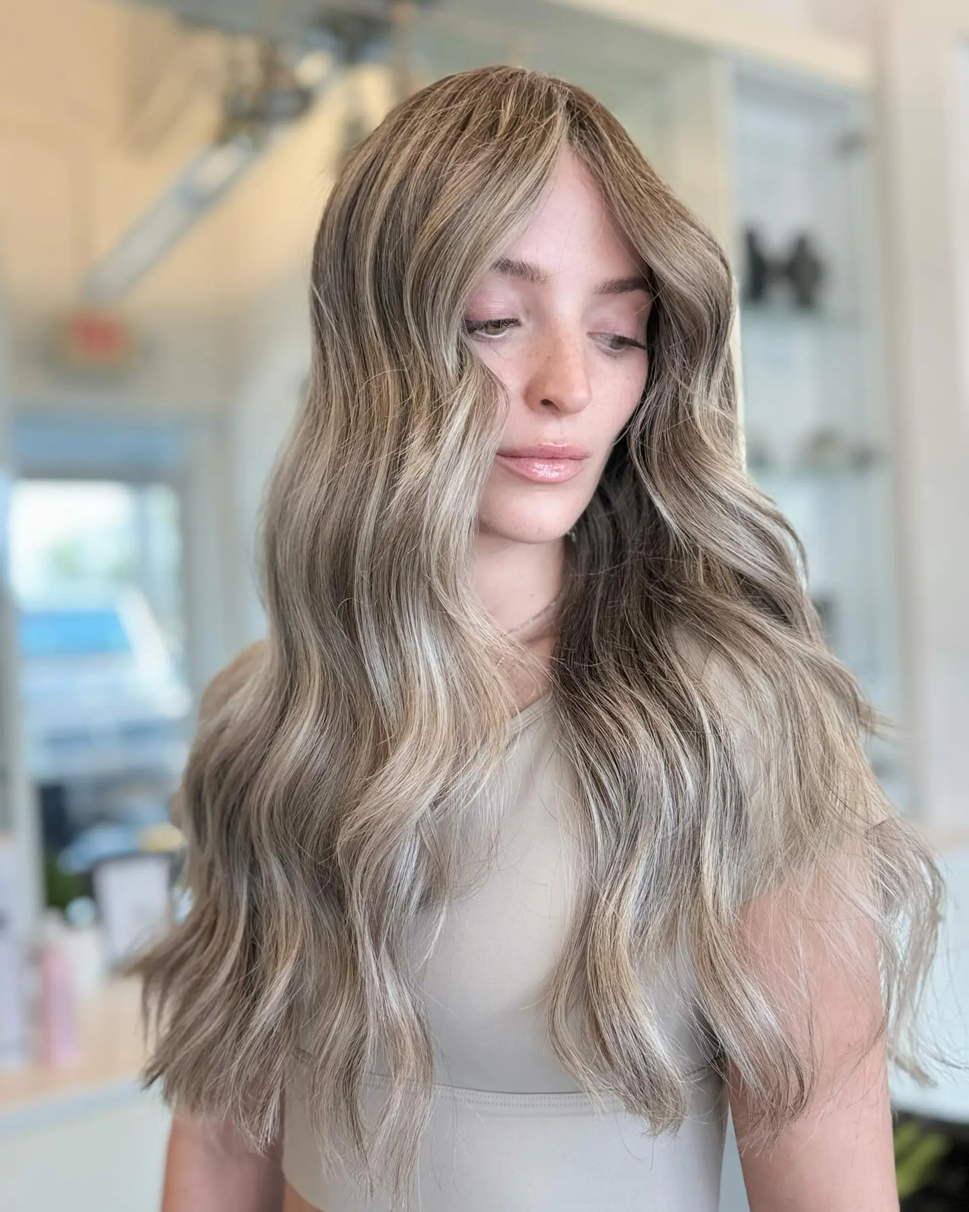 Long, flowing beach waves with a dimensional blonde balayage. 6