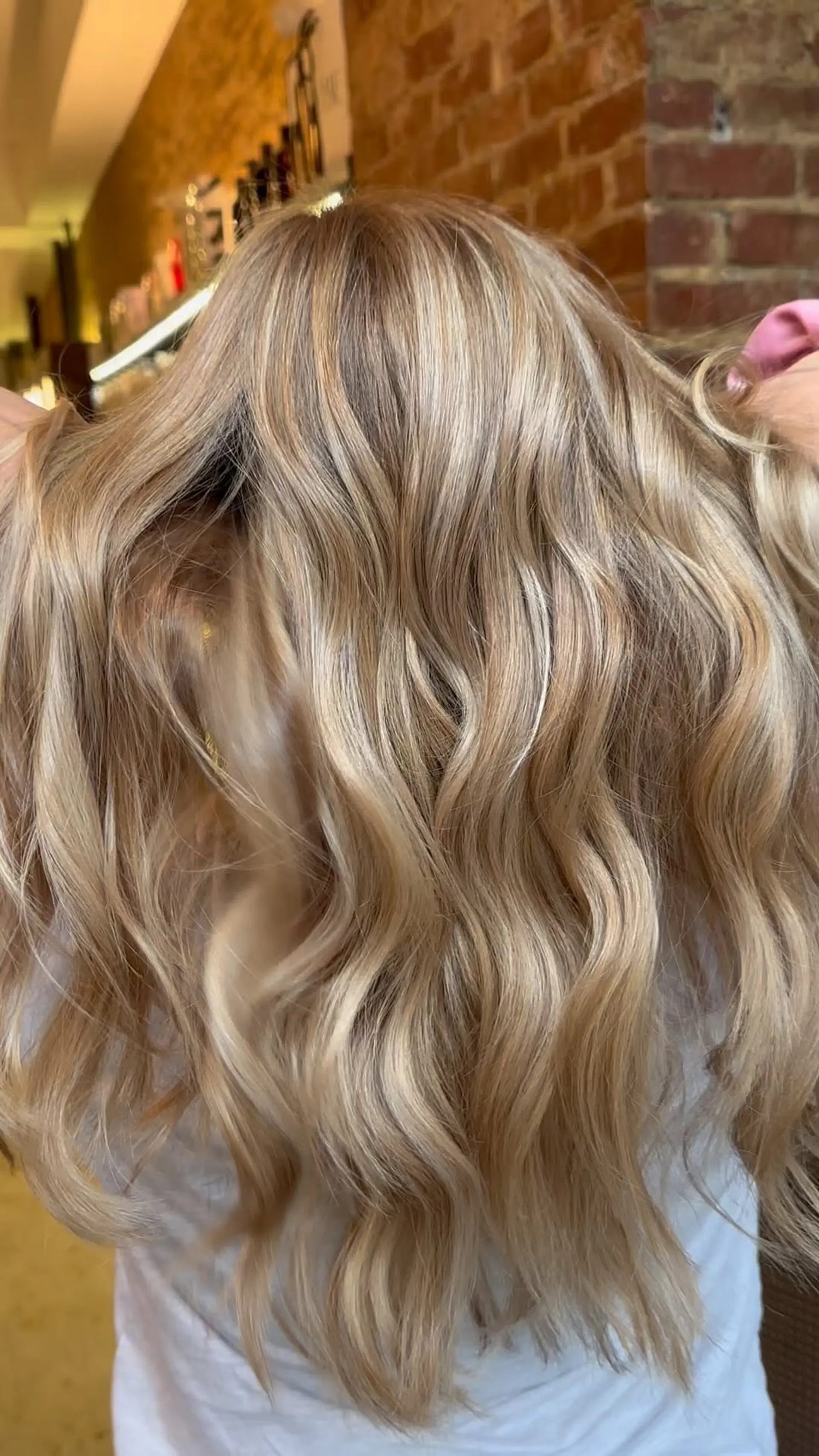 A dimensional ash blonde balayage with soft, cool-toned highlights blended throughout. 1