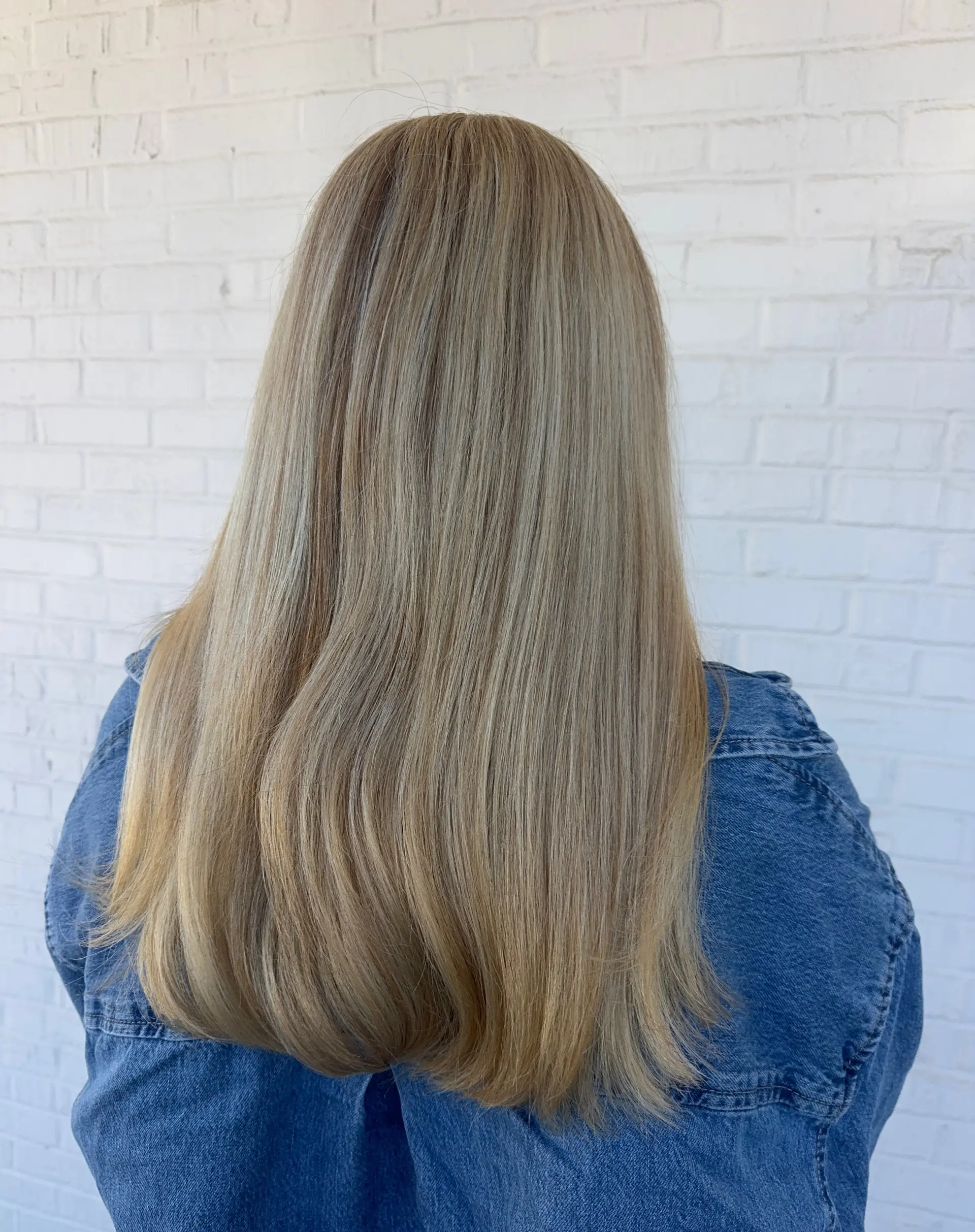 Long, straight ash blonde hair featuring seamless, finely blended highlights with soft dimension. 1