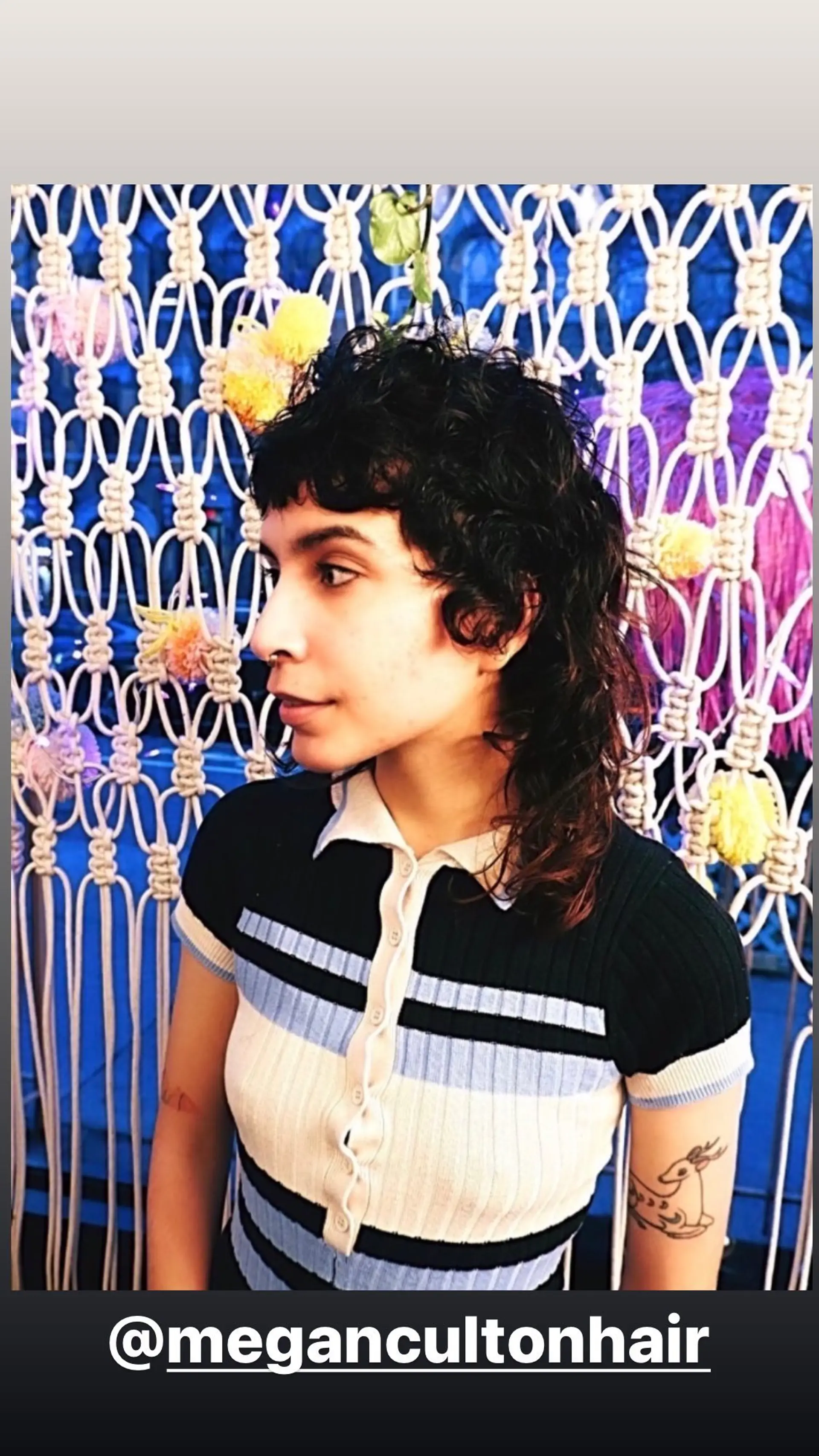 A trendy curly shag mullet with short, textured bangs and choppy layers. 1