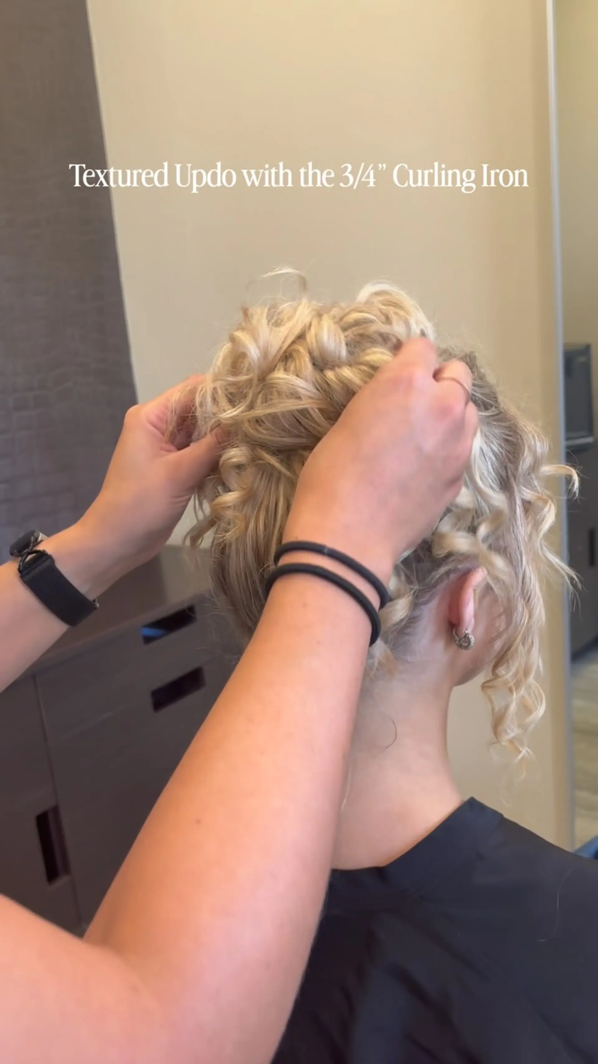 A romantic textured blonde updo styled with defined curls and loose, face-framing tendrils. 1