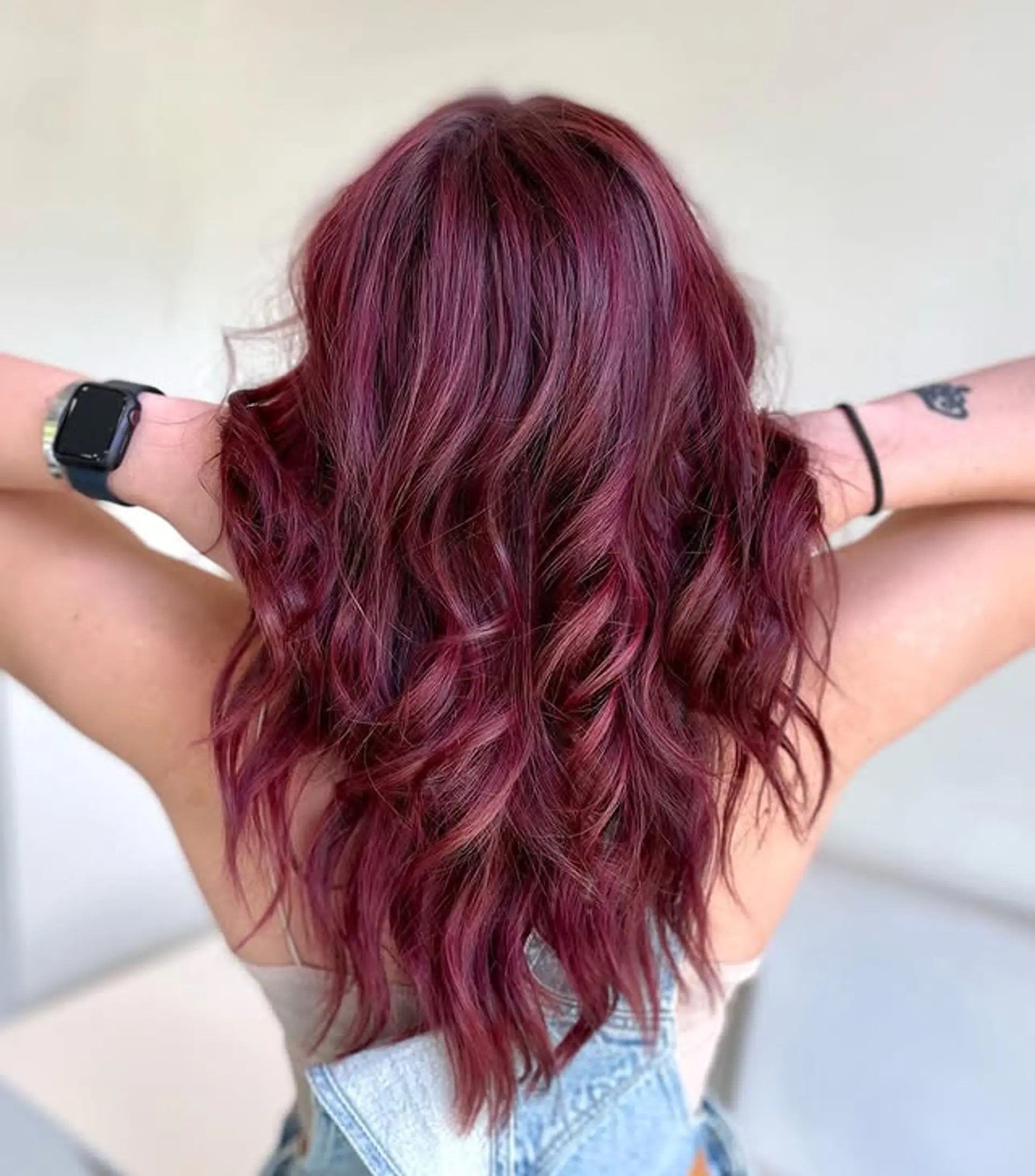 Long, wavy hair with face-framing blonde highlights and a rich mulberry base color. 1