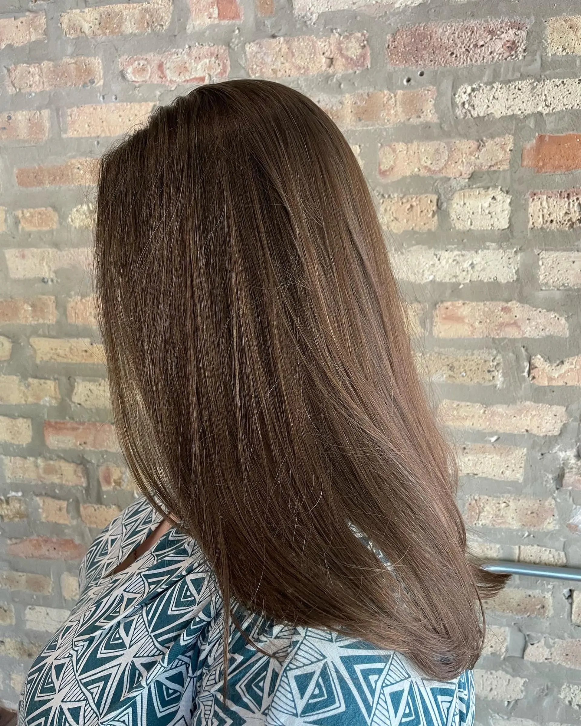 A sleek, smooth long haircut featuring clean ends with a gentle under-curl blowout. 1