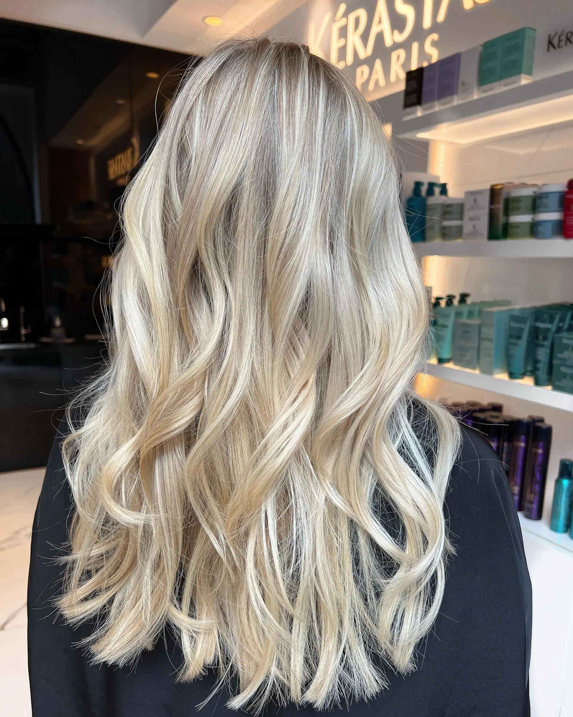 Long dimensional blonde hair styled in soft, loose waves. 1
