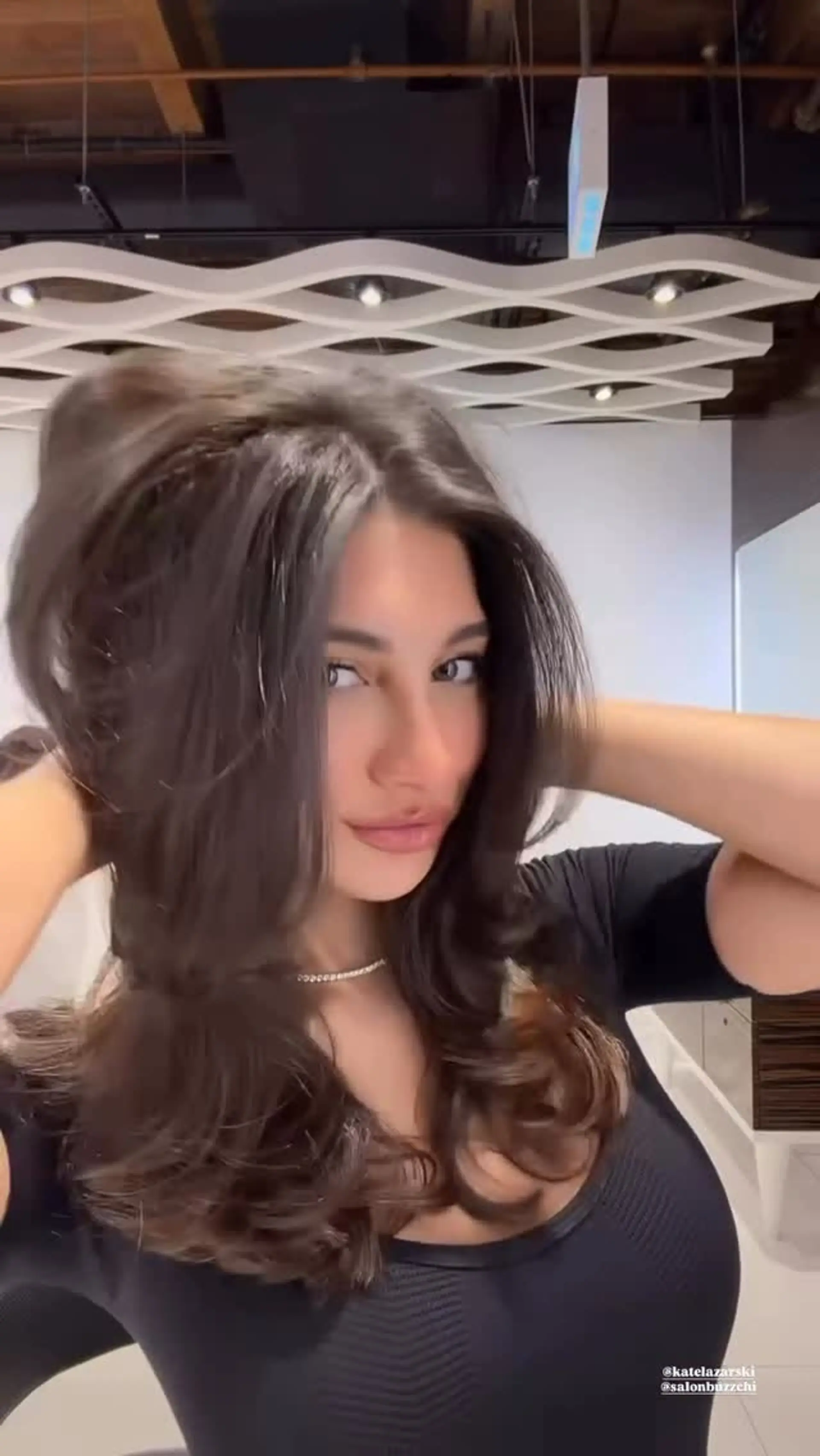 Voluminous layered blowout featuring soft face-framing sections and bouncy curled ends. 1
