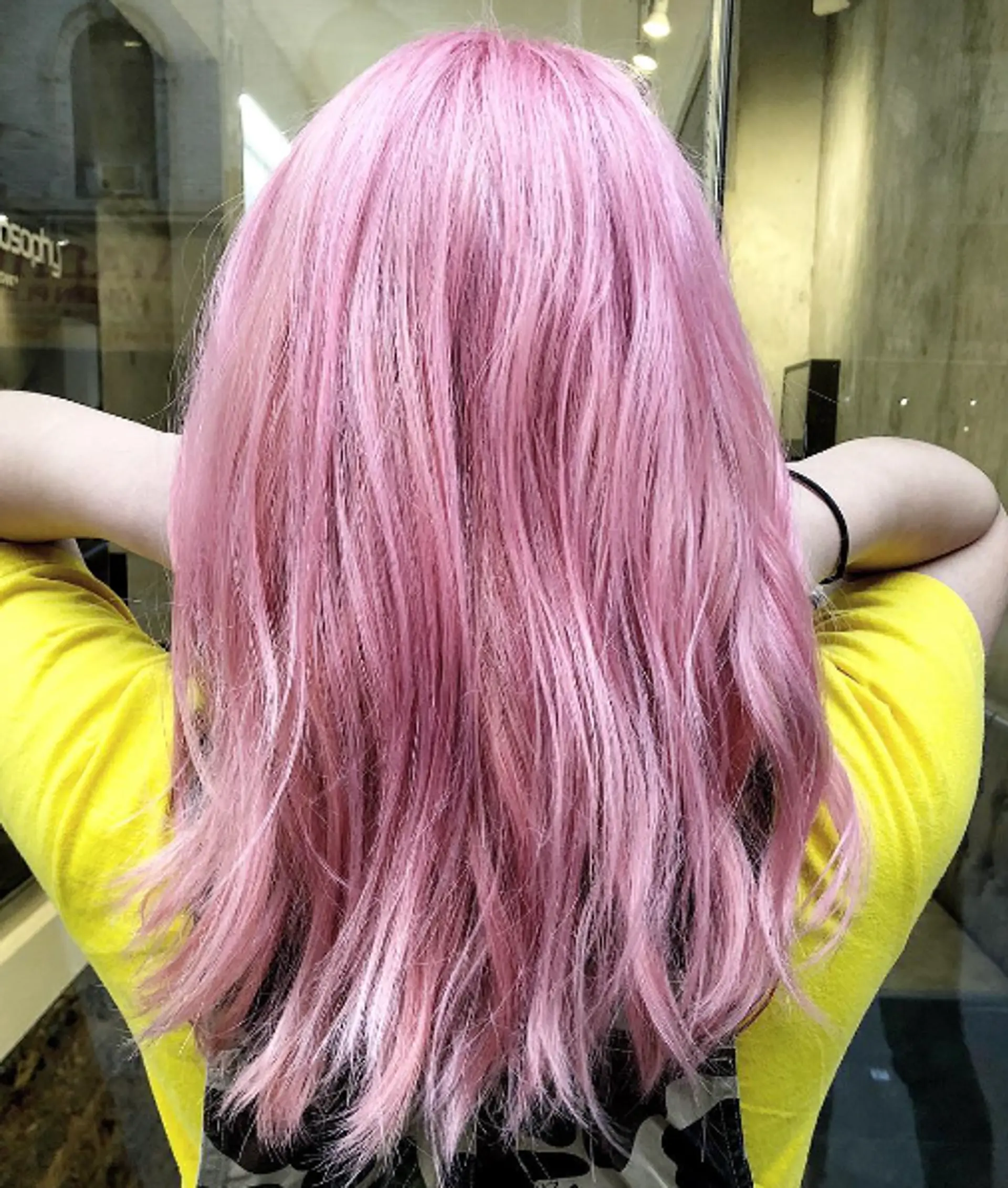 Long, straight hair dyed vibrant pink with soft layers and a silky, smooth appearance. 1