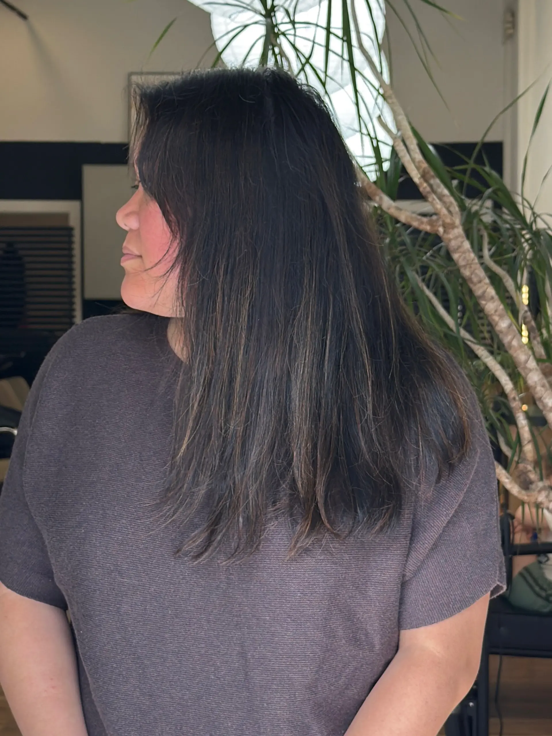 Medium-length dark brunette hair seamlessly blended with K-tip extensions for natural density and subtle dimension. 1