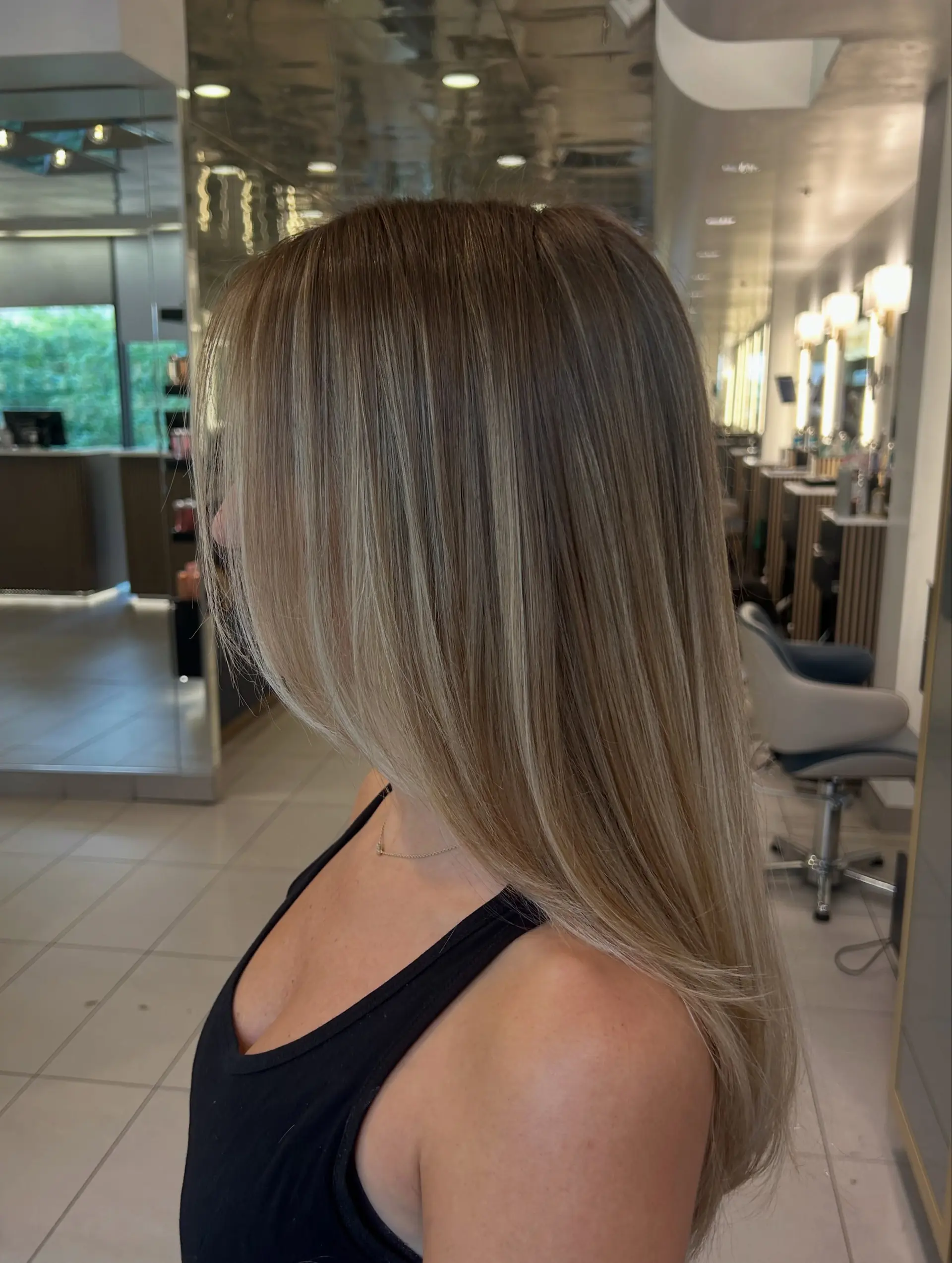 Long, sleek straight hair with a seamless blonde balayage and soft face-framing layers. 1