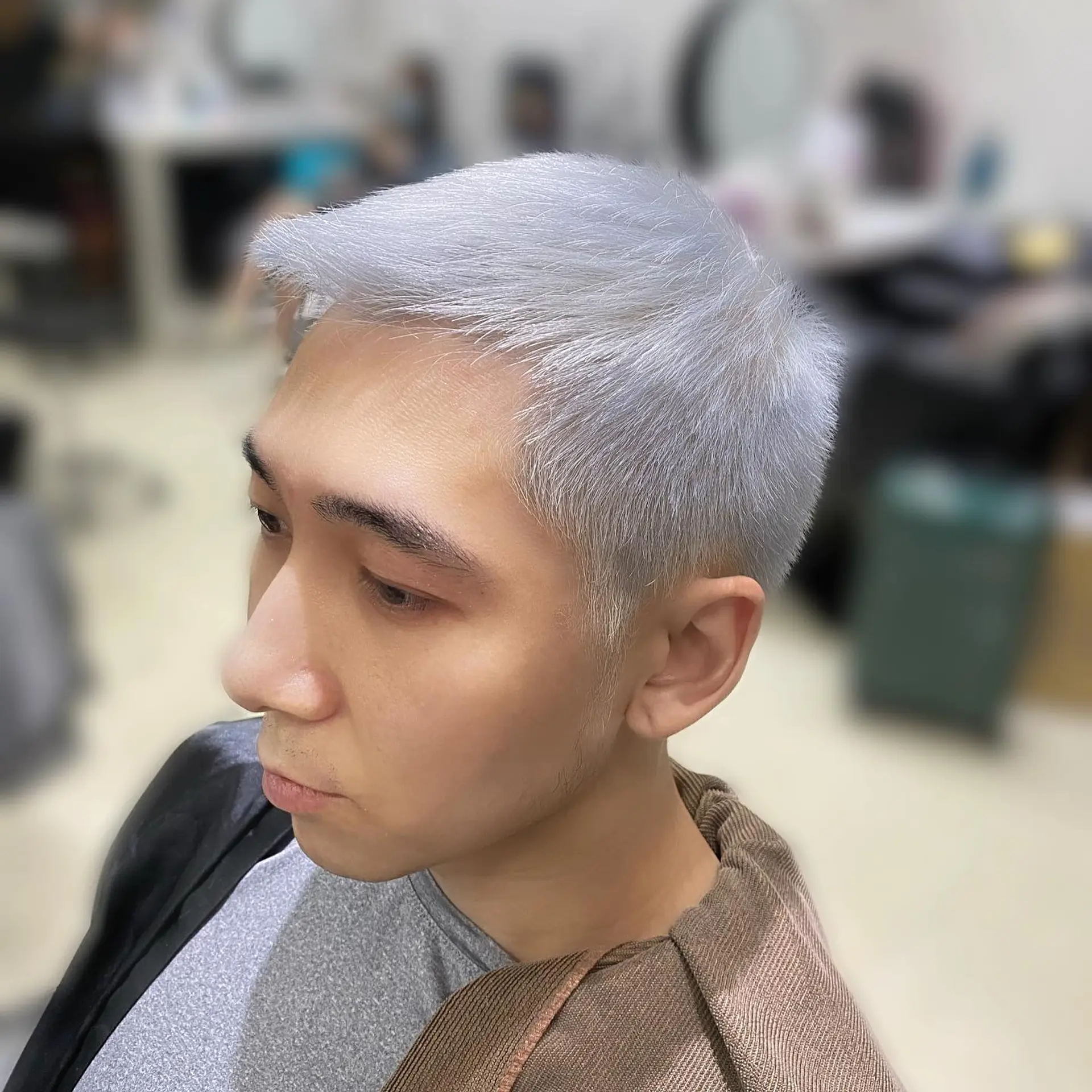 A very short buzz cut, bleached to a platinum blonde shade. 2