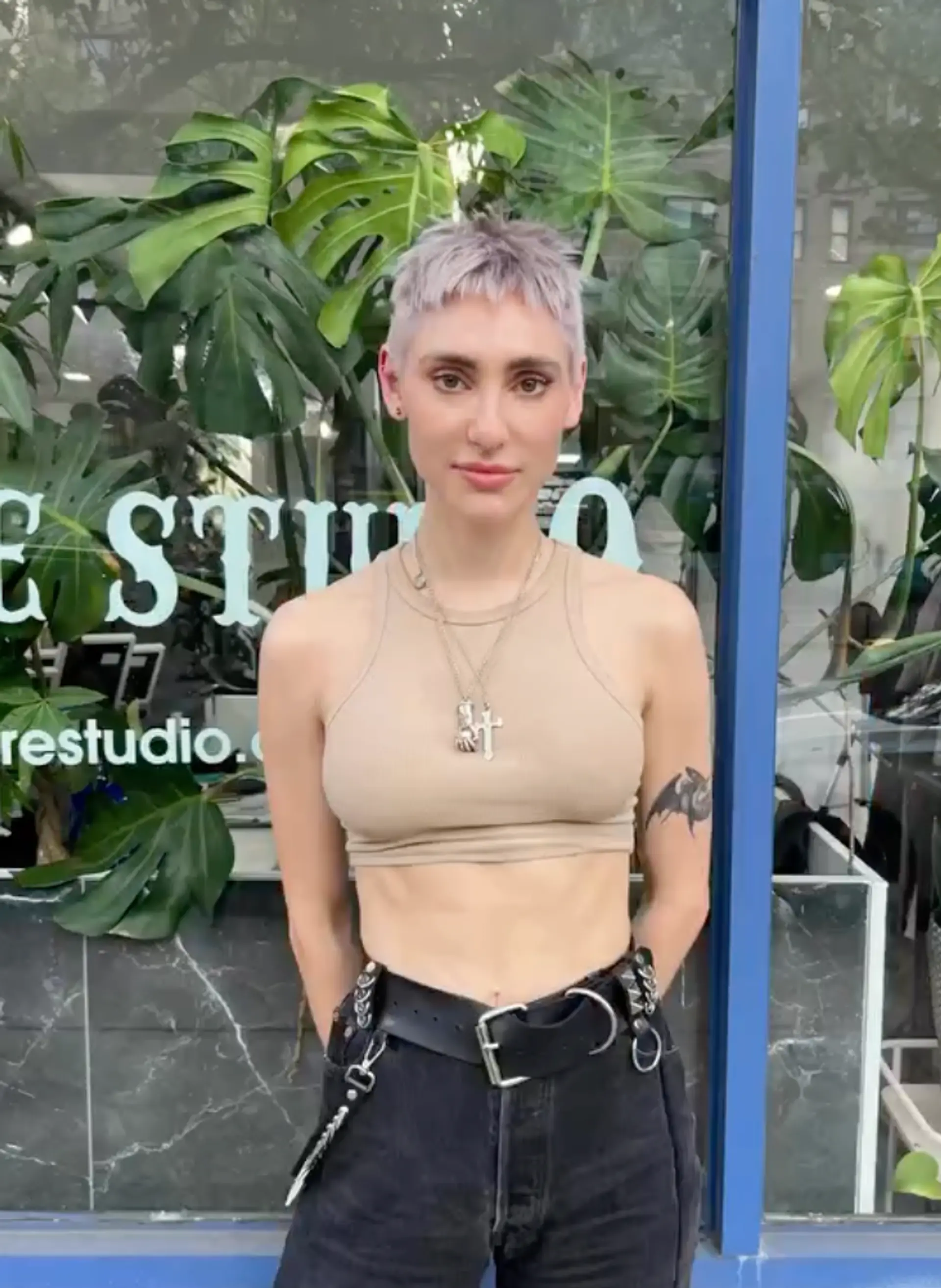 A very short, platinum blonde, and silver pixie cut with a textured fringe and tapered sides. 1