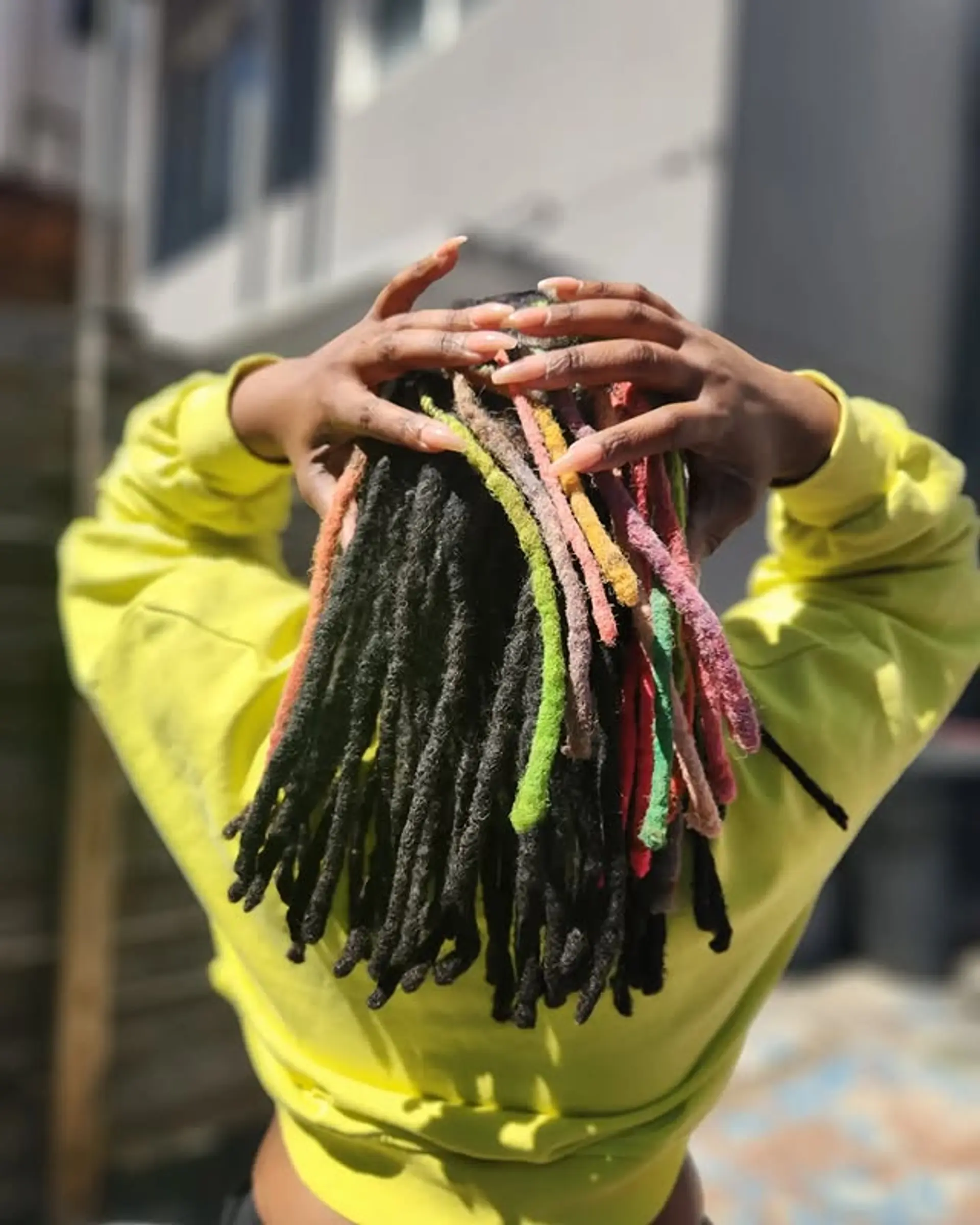 Medium locs with a playful rainbow accent. 1