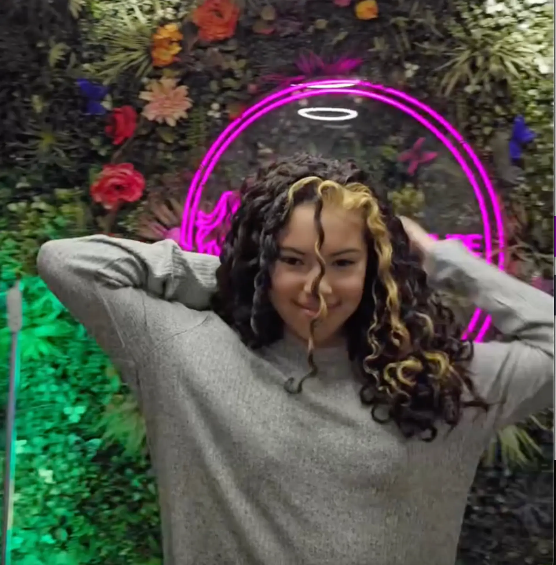 Long, curly black hair with bold blonde highlights and a striking central blonde streak, giving a voluminous and playful vibe. 1