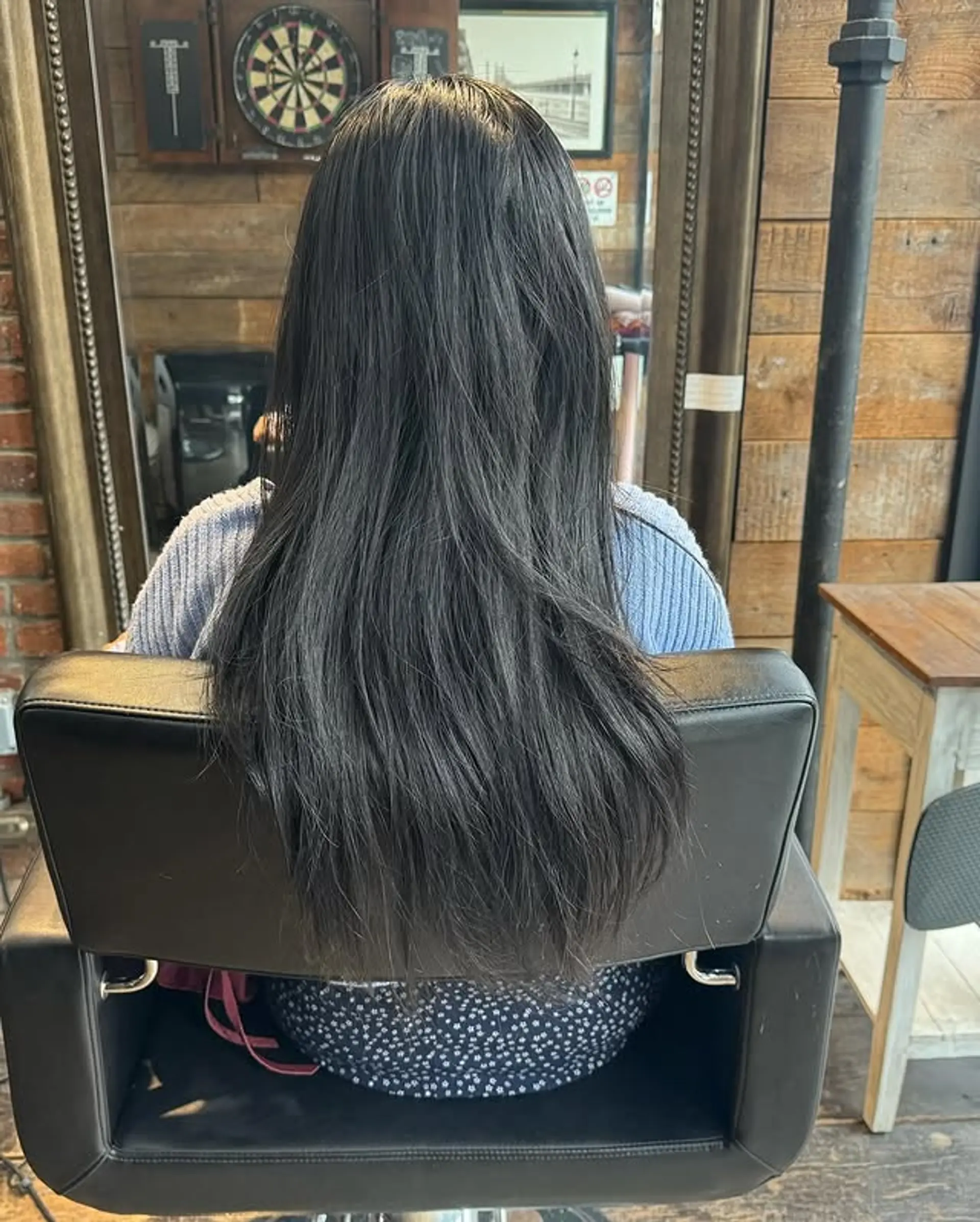 This is a long layered haircut with face-framing bangs. 1