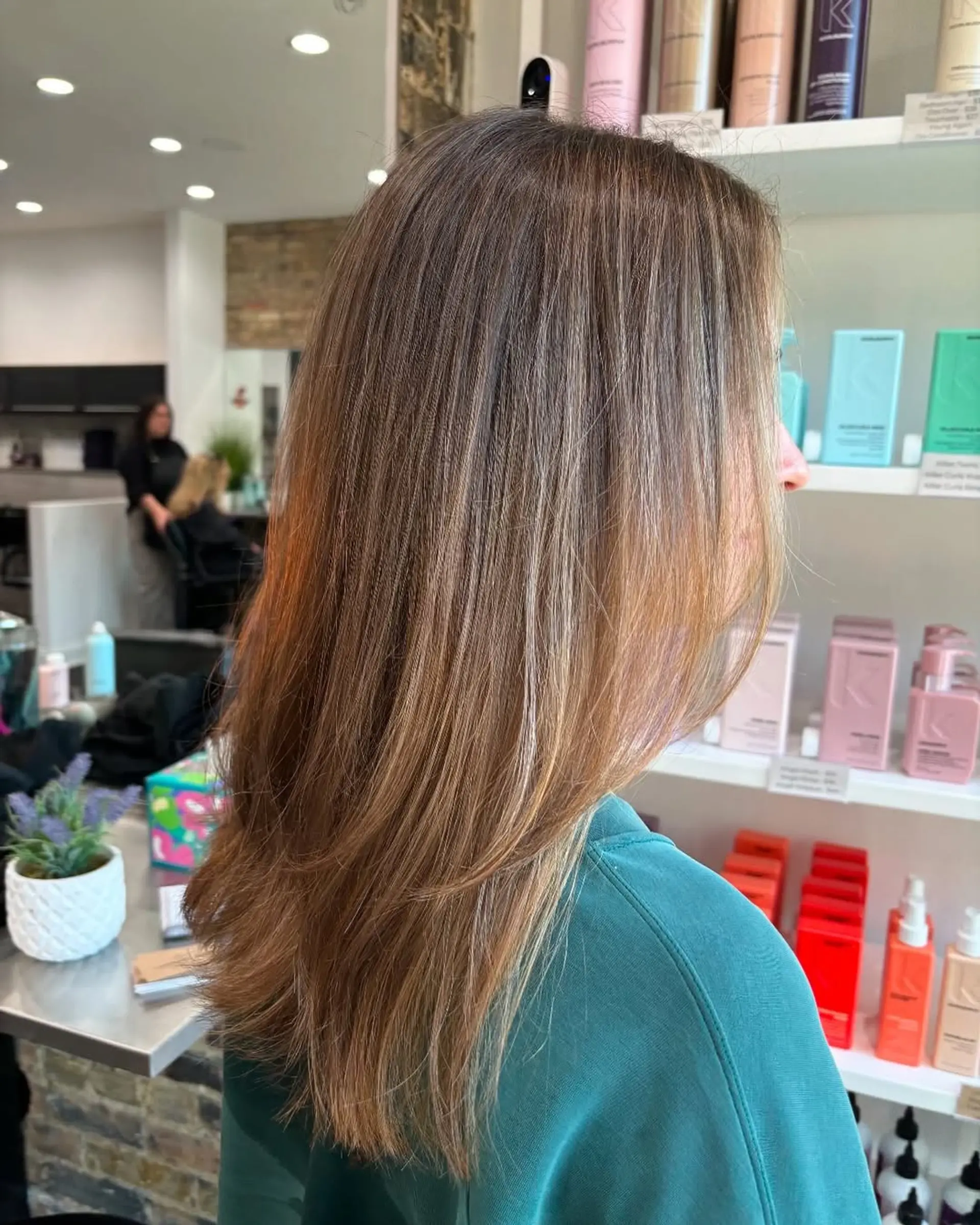 This chic style combines a medium-length layered cut with a stunning caramel bronde balayage, creating depth and movement with its seamlessly blended dimensional color. 2