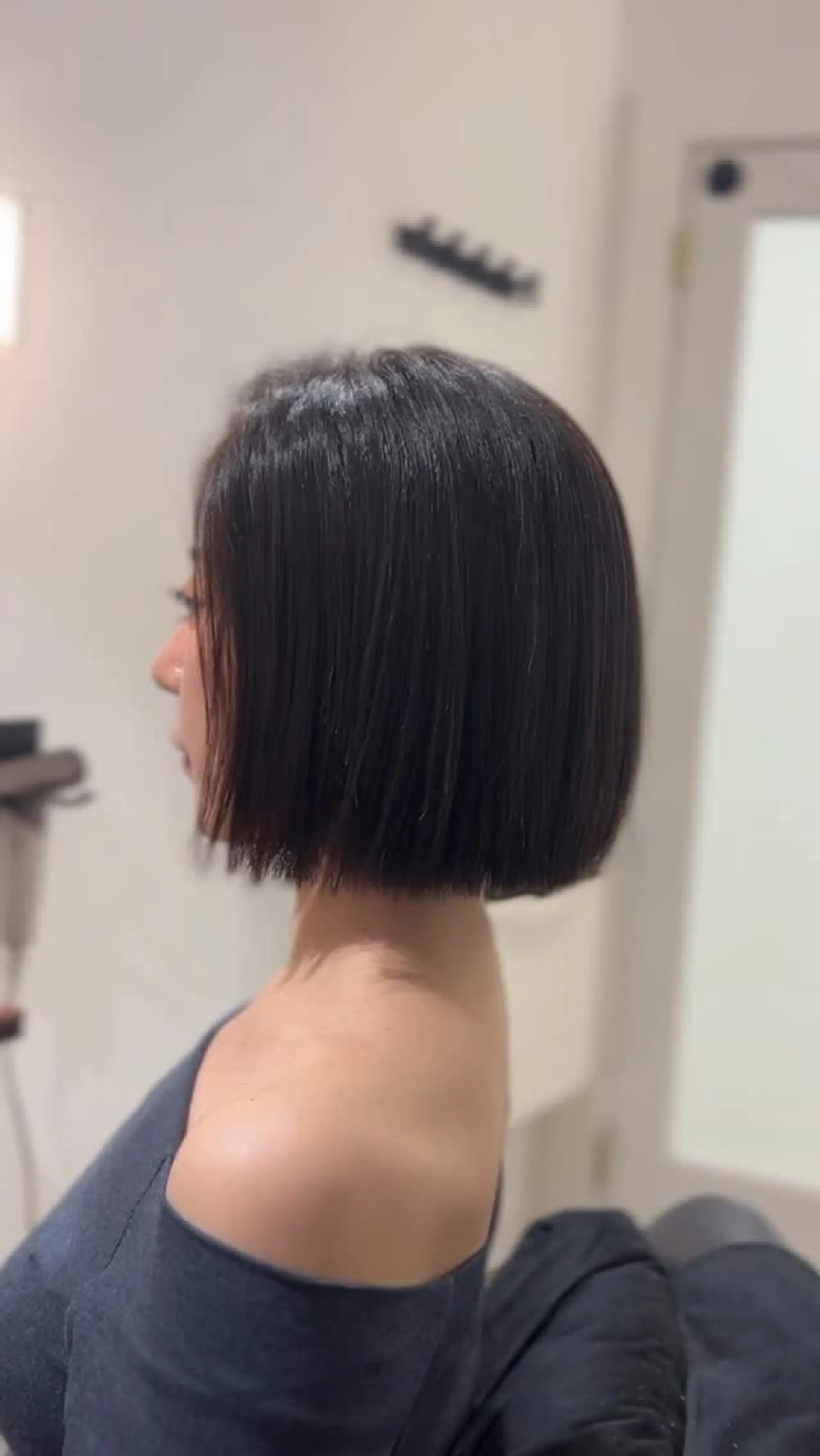 A sleek chin-length bob cut cleanly at the neckline with softly textured ends for lightweight movement. 1