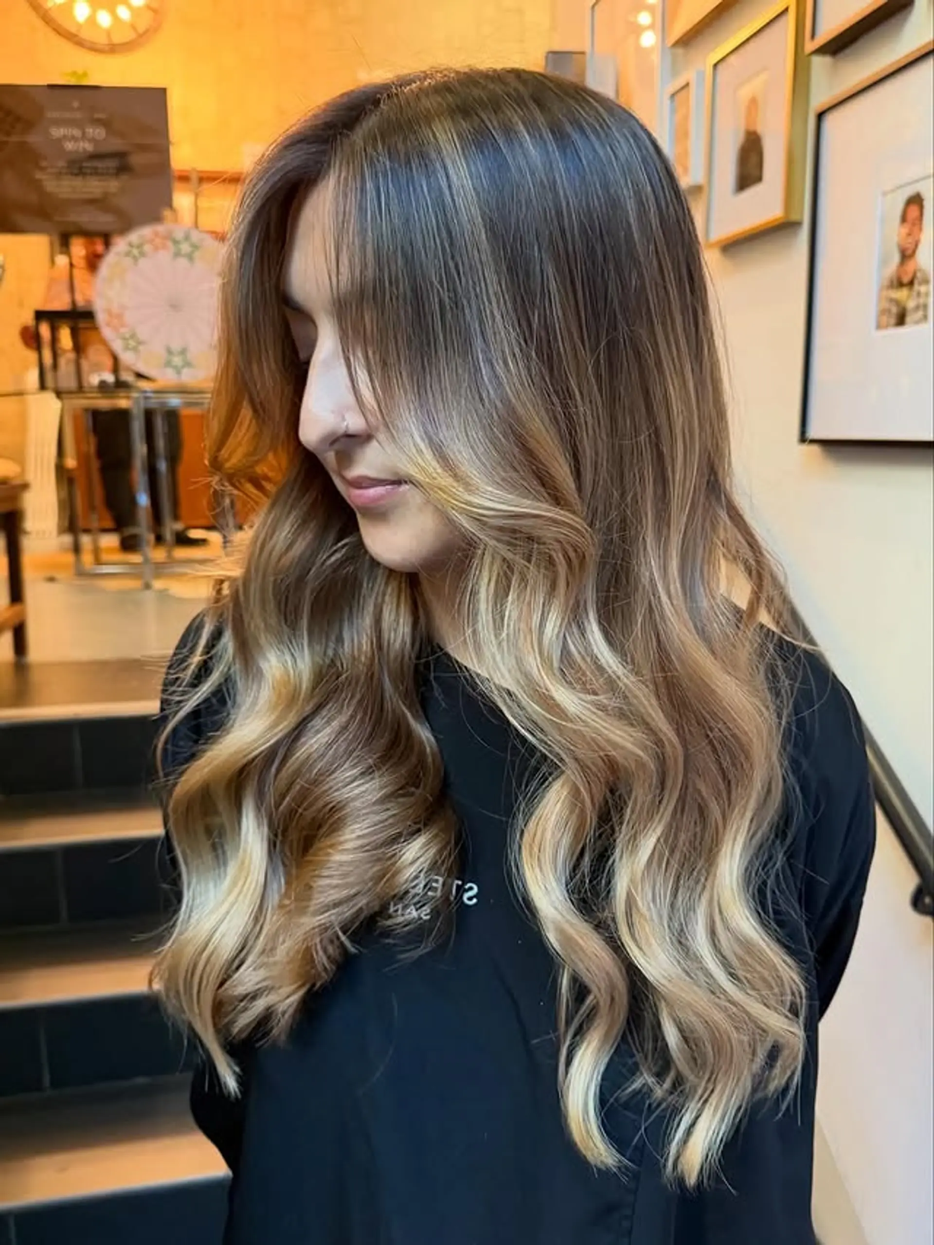 Long, wavy bronde balayage with face-framing curtain bangs. 1
