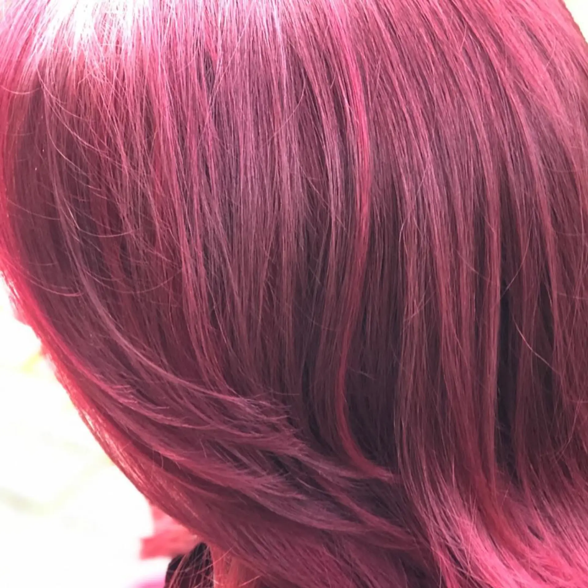 A close-up shot featuring a rich, dimensional magenta-fuchsia vivid hair color with soft feathered layers. 1