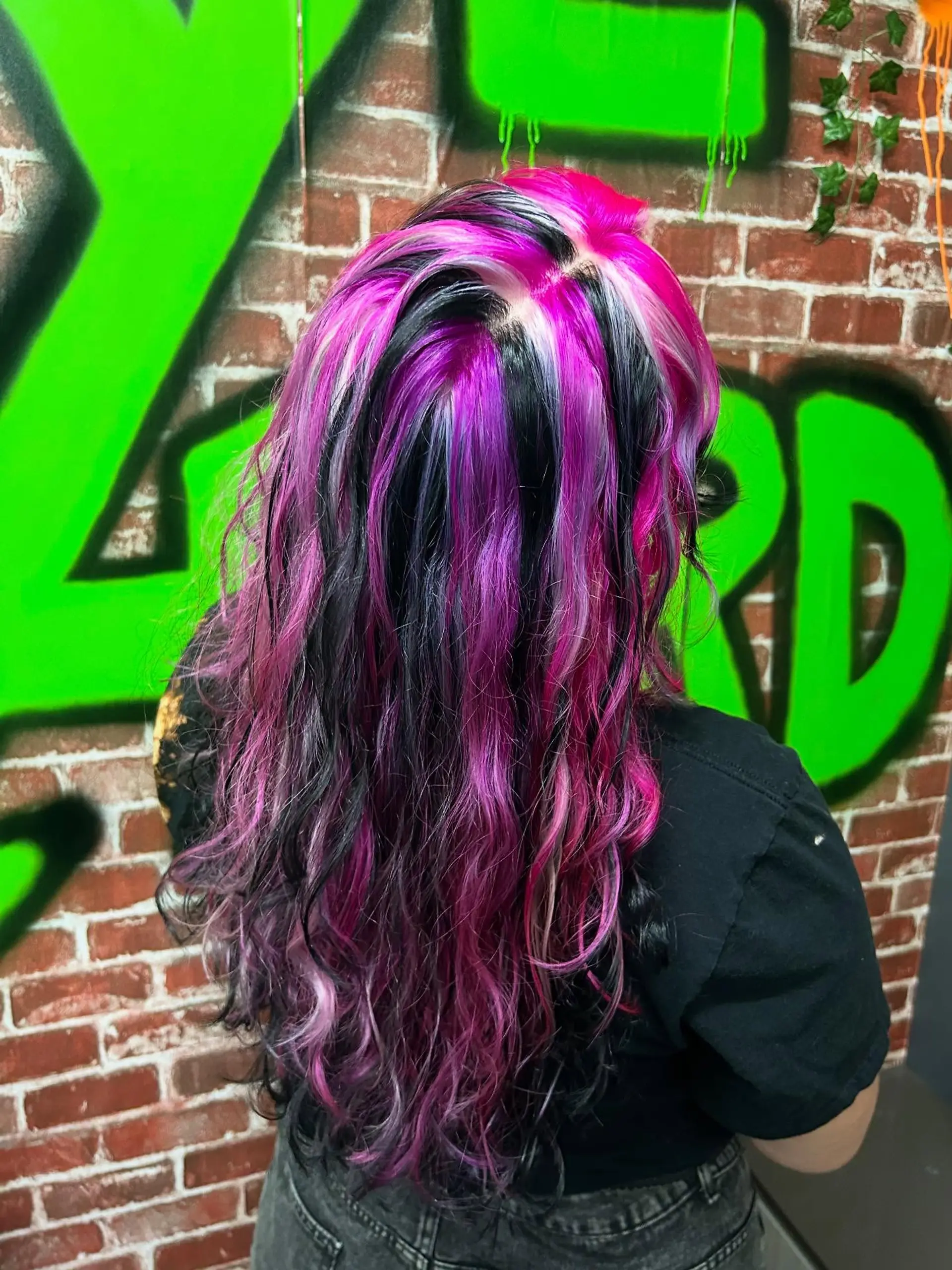 Long wavy hair featuring bold, high-contrast chunky highlights in bright magenta pink, jet black, and icy white. 1