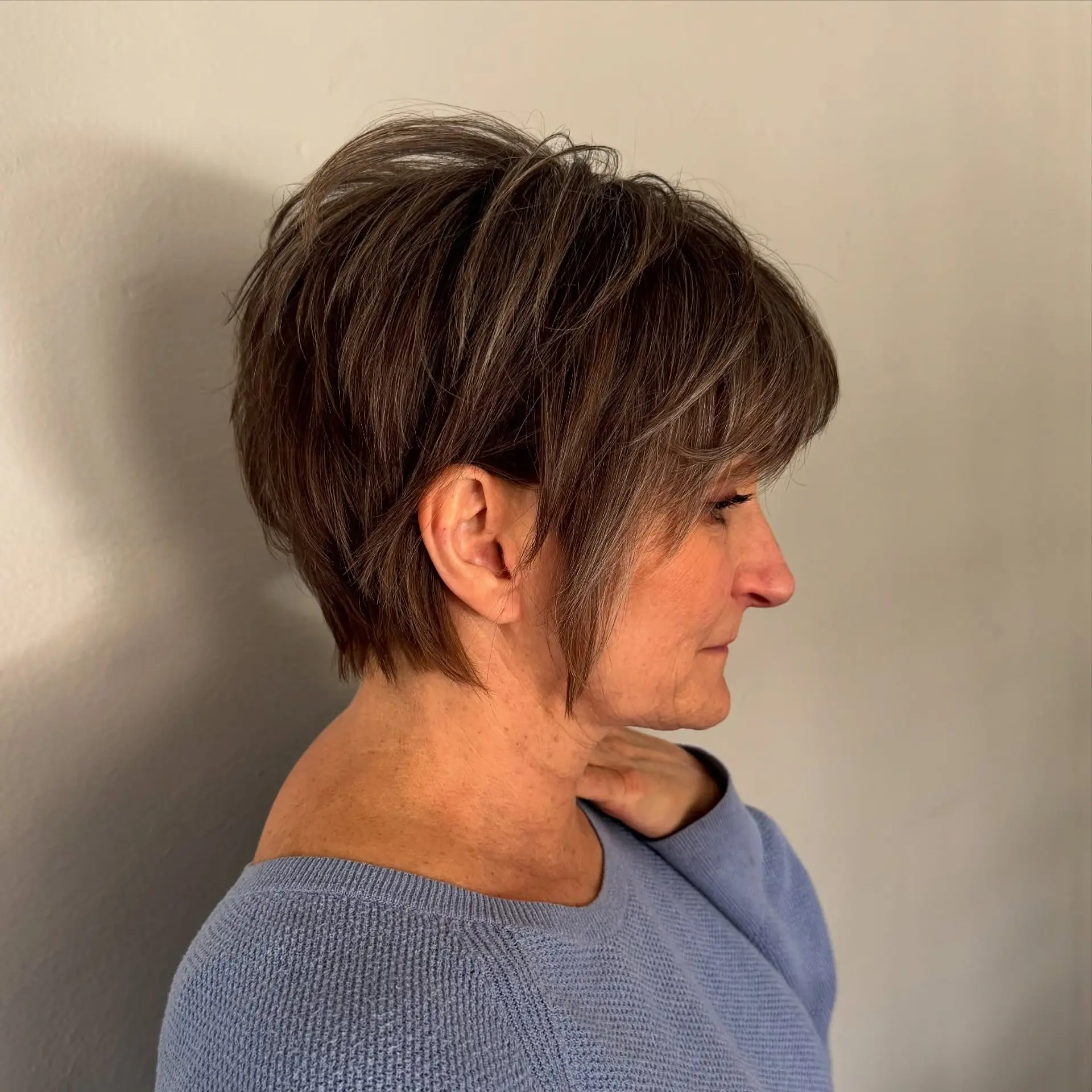 A textured pixie bob cut with wispy, dimensional layers and face-framing pieces. 1