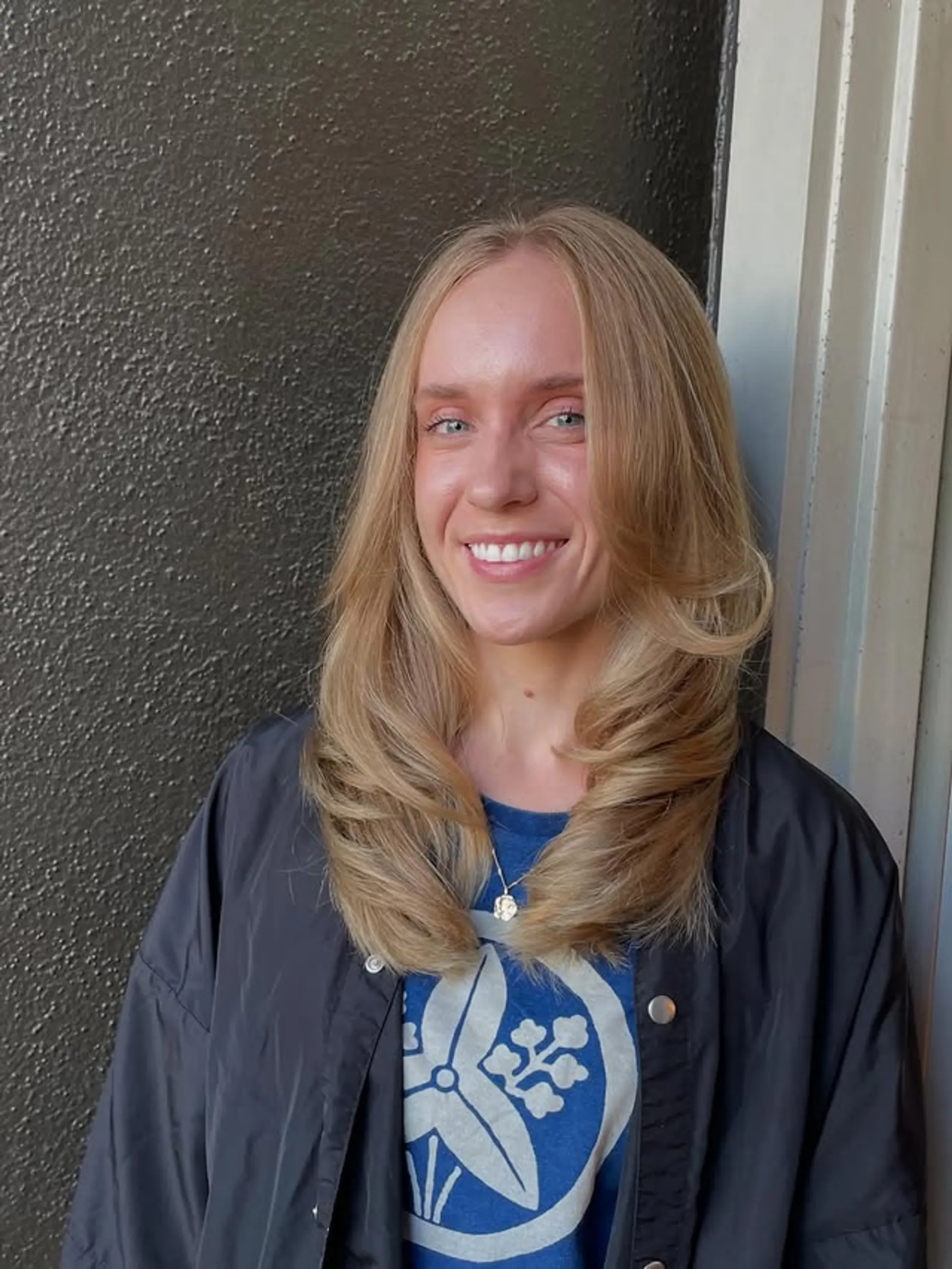 Long, layered with face-framing layers and curtain bangs, styled in a soft blowout. 1