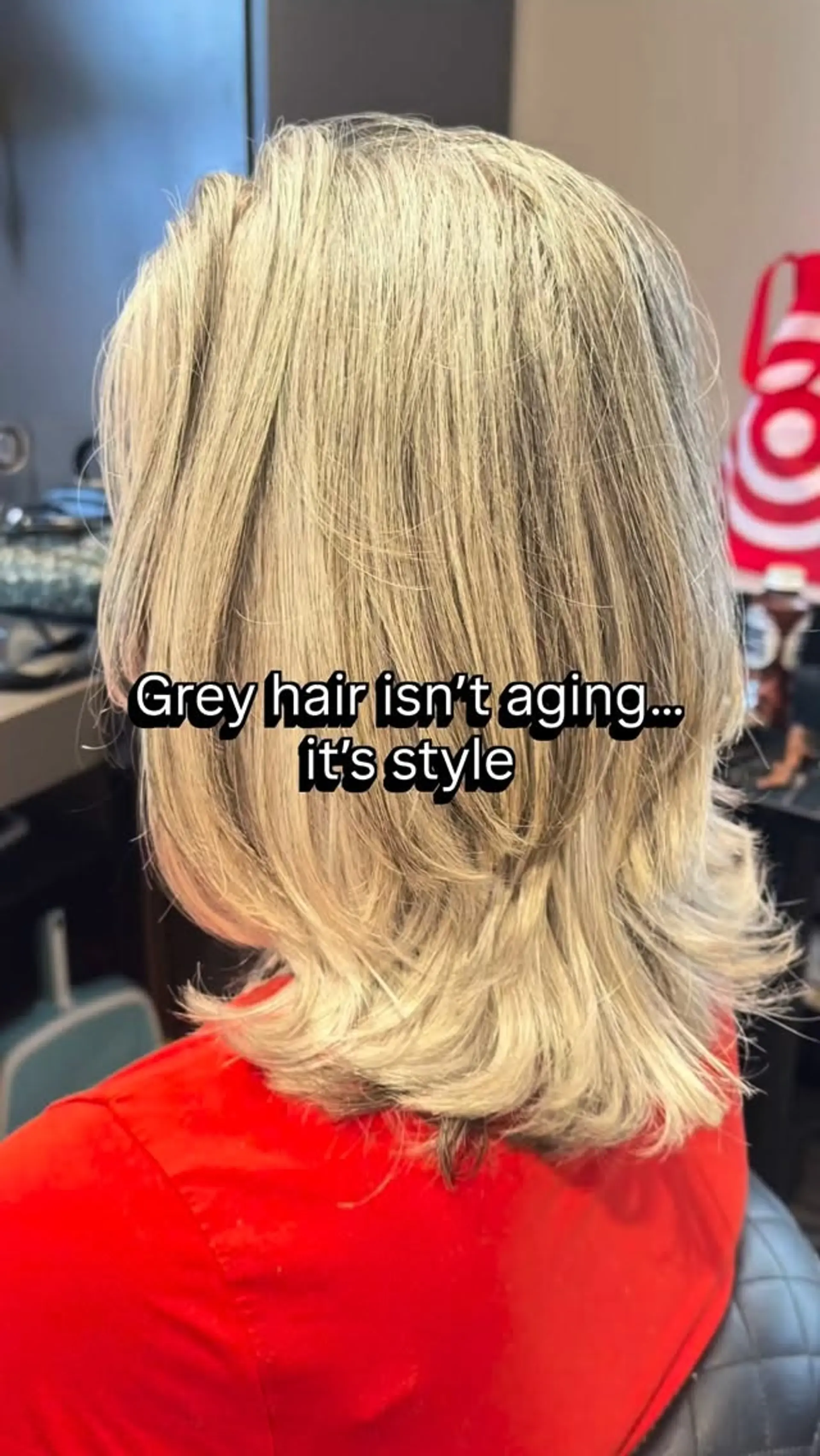 A textured shoulder-length haircut with soft layers and flipped ends that highlight natural gray and silver tones. 1