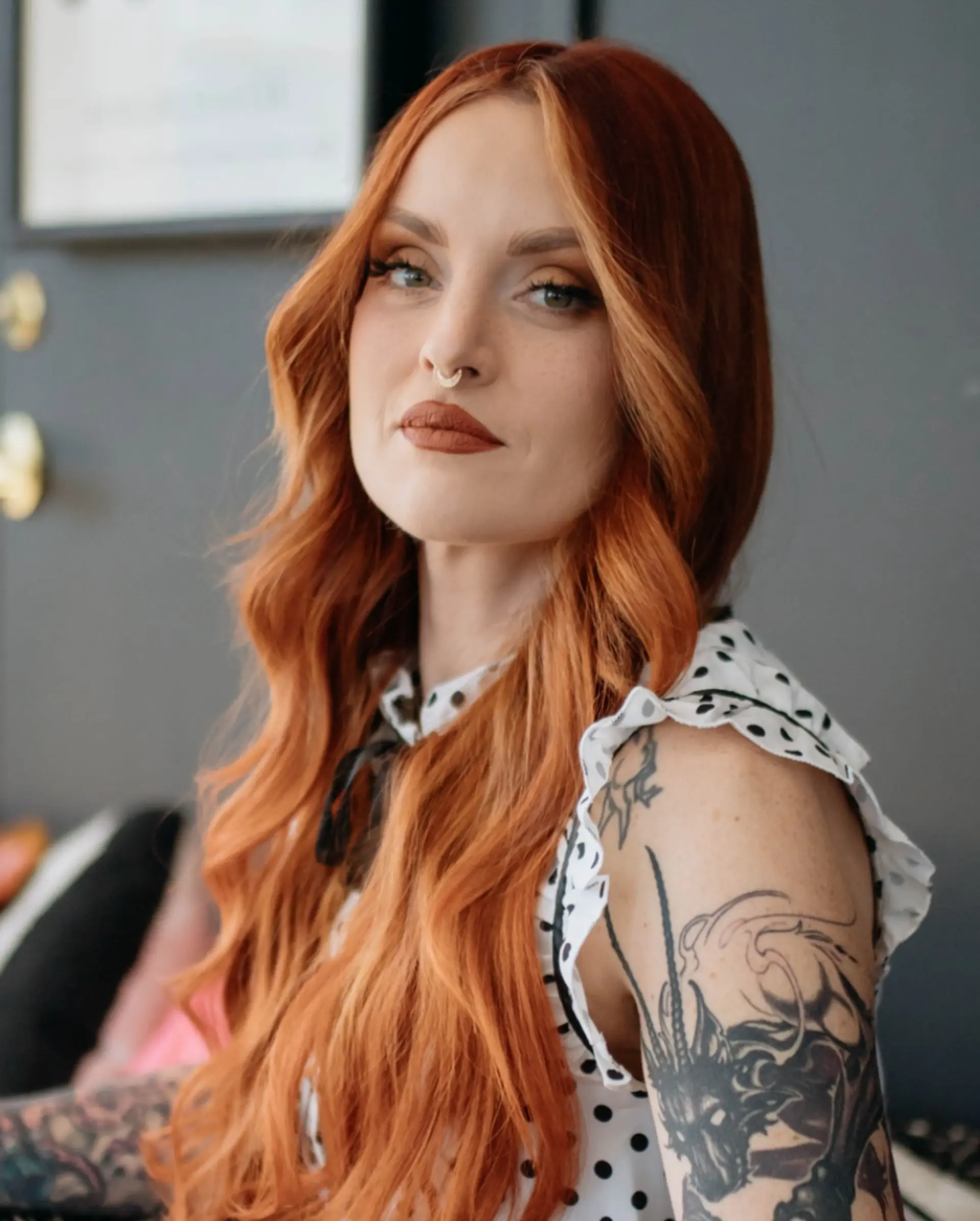 Vibrant dimensional copper hair styled in soft, cascading waves with face-framing dimension. 1