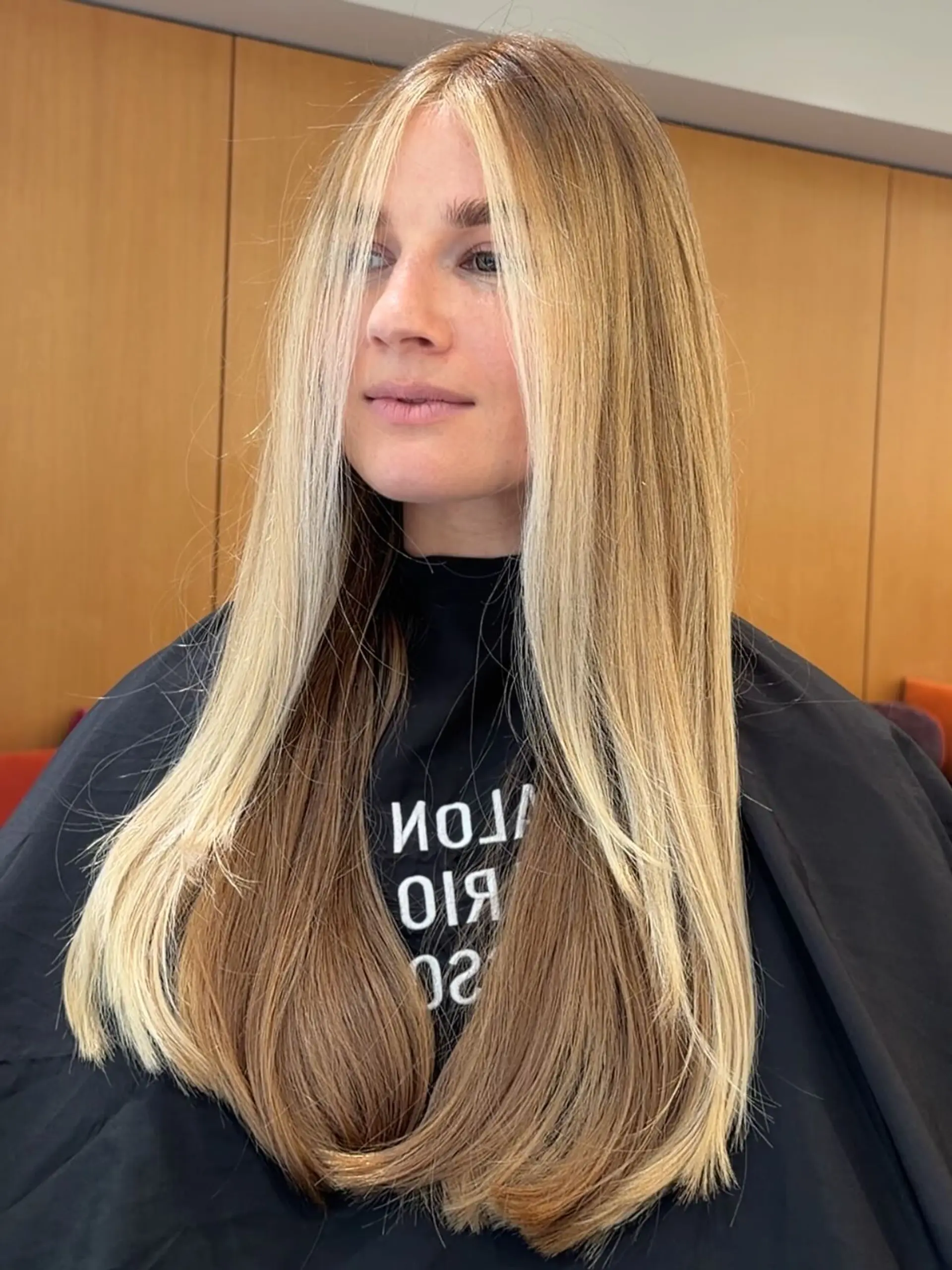 Long, sleek straight hair featuring bold, bright blonde face-framing highlights contrasted against a light brown base. 1