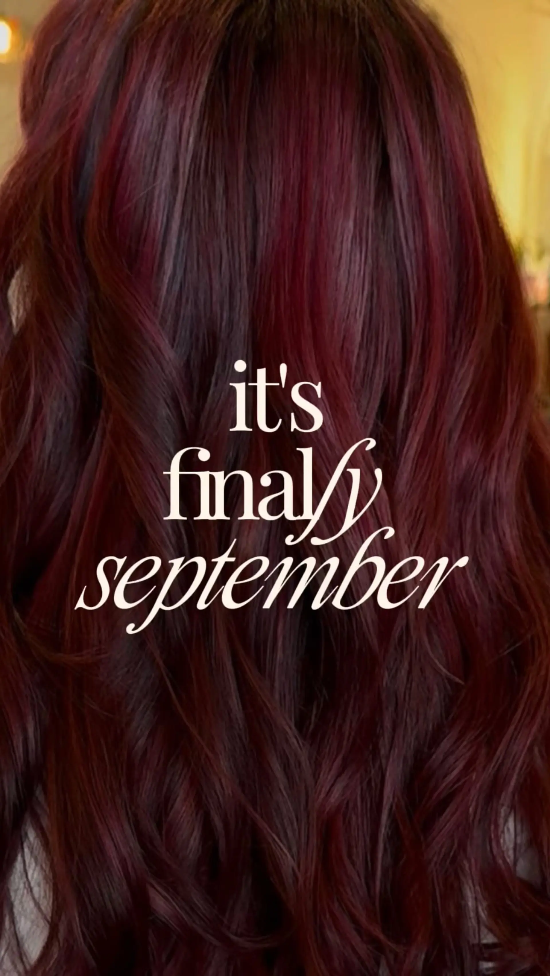 Long hair colored in a rich deep burgundy and wine red, styled with loose, dimensional waves. 1