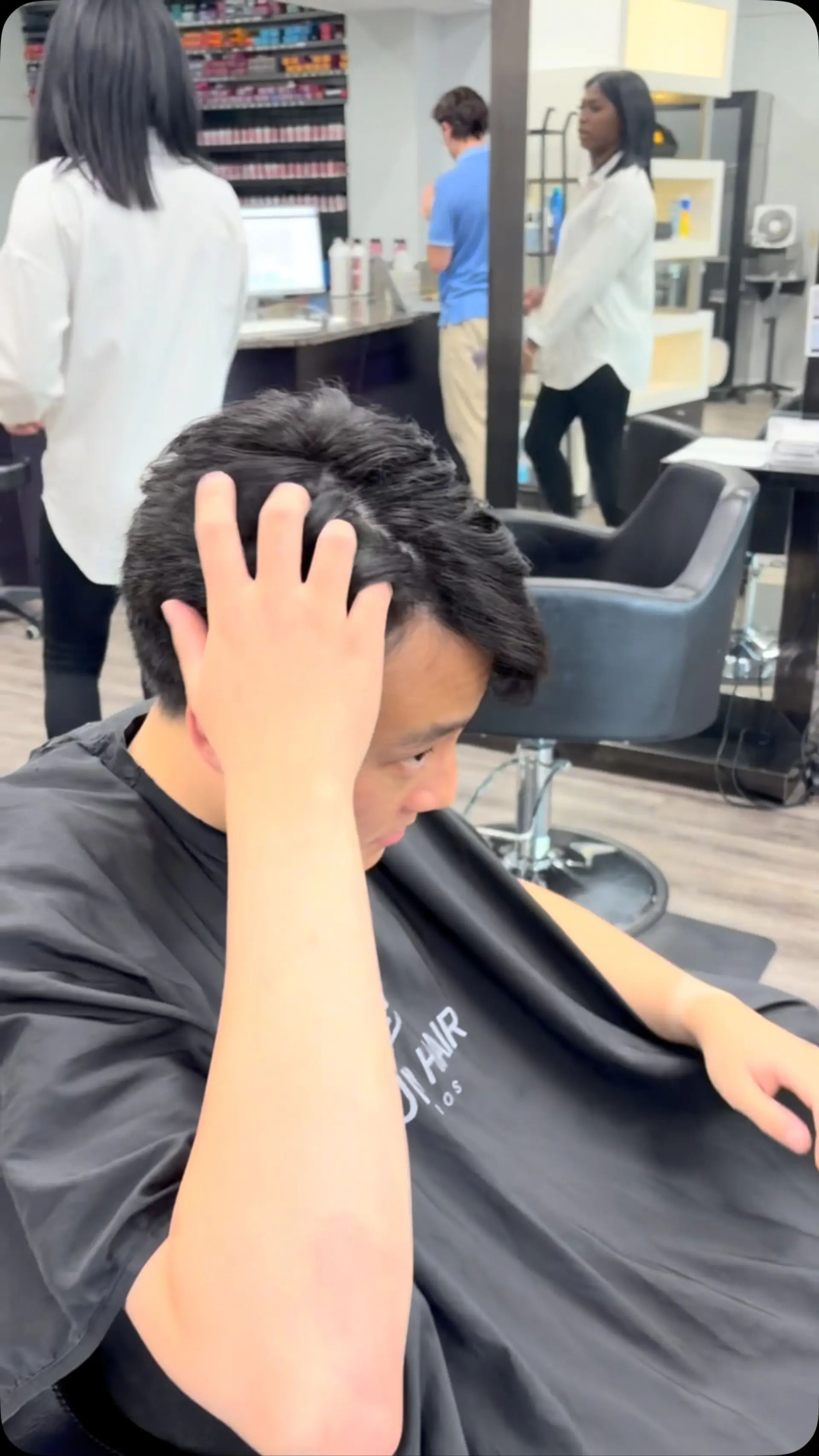 A layered men's cut styled with natural texture and volume on top. 1