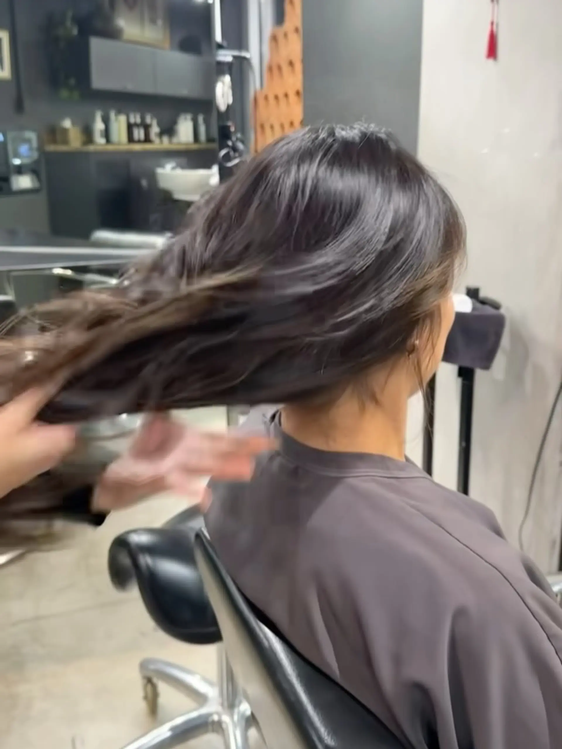Long, flowing dark brunette hair cut with soft textured layers to create effortless movement. 1