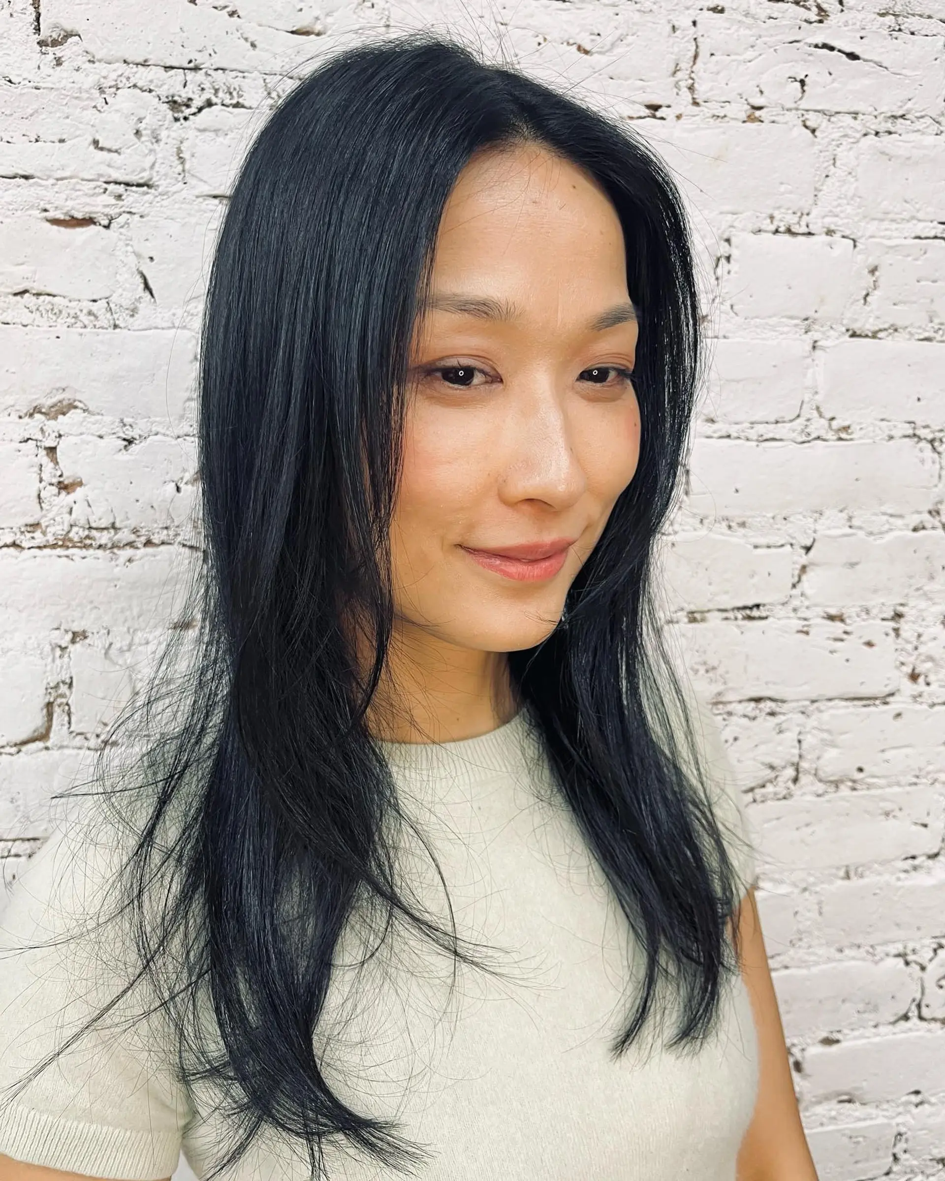 Straight, long jet-black hair cut with soft face-framing layers and wispy ends. 1